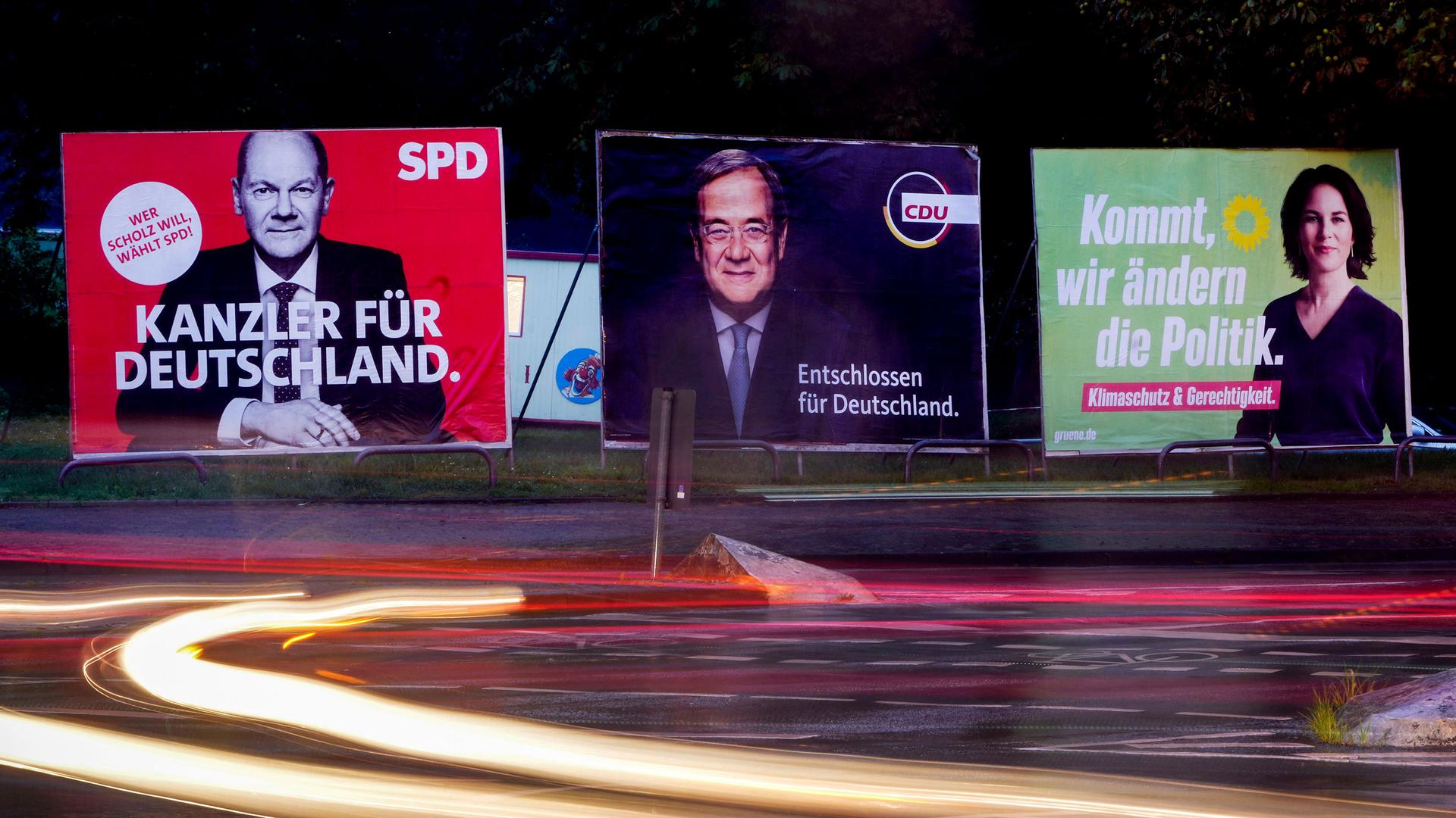 Three elections posters show Social Democratic top candidate for chancellor Olaf Scholz, left, Christian Democratic top candidate Armin Laschet, center, and top candidate of the Greens Annalena Baerbock in Frankfurt, Germany, Wednesday, Sept. 15, 2021. 