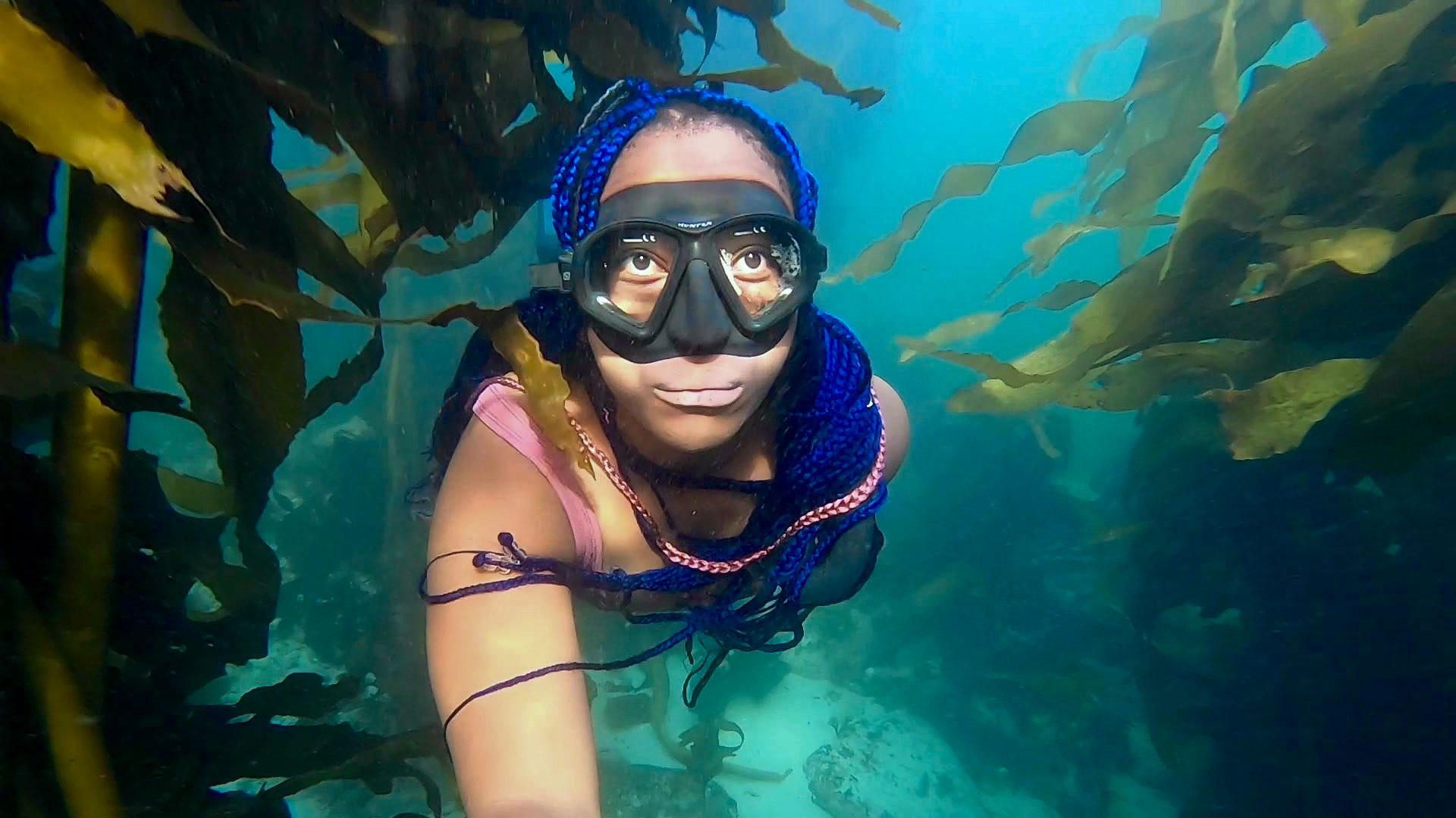 South Africa's "Black Mermaid," Zandile Ndhlovu, enjoys sunrise dives in the kelp forest. 