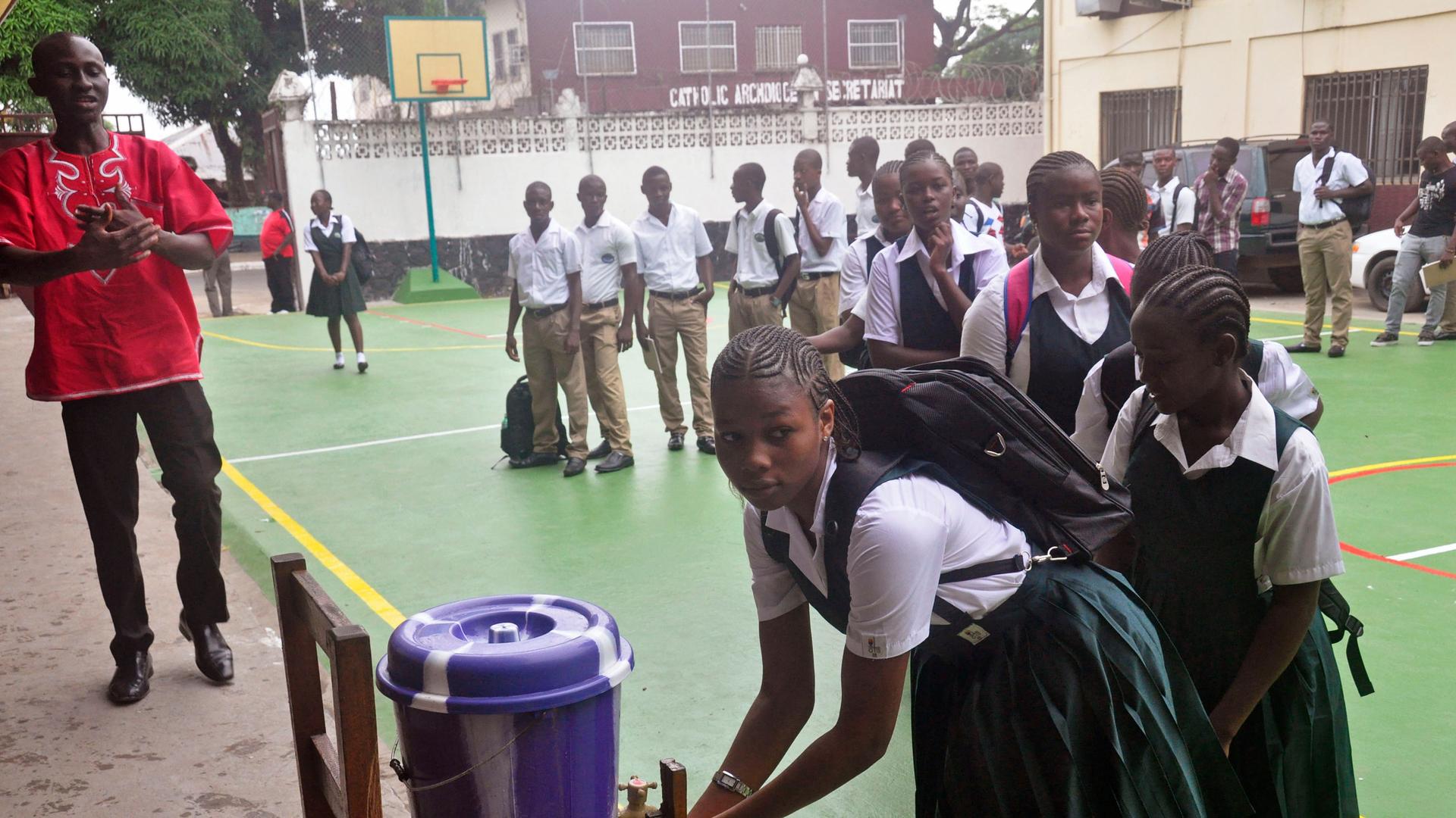 Liberian school children in the courtyard at Cathedral High School as students arrive in the morning to attend class in Monrovia, Liberia, Monday, Feb. 16, 2015. 