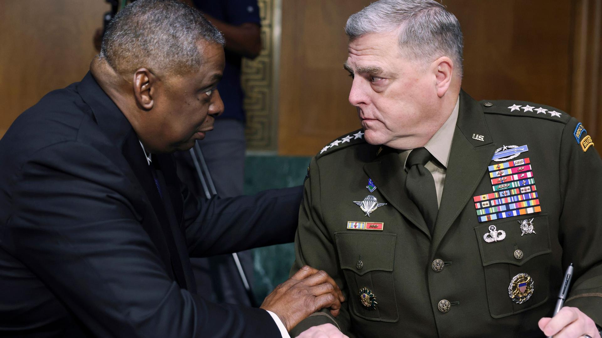 Secretary of Defense Lloyd Austin and Chairman of the Joint Chiefs Chairman Gen. Mark Milley are shown sitting and facing each other.