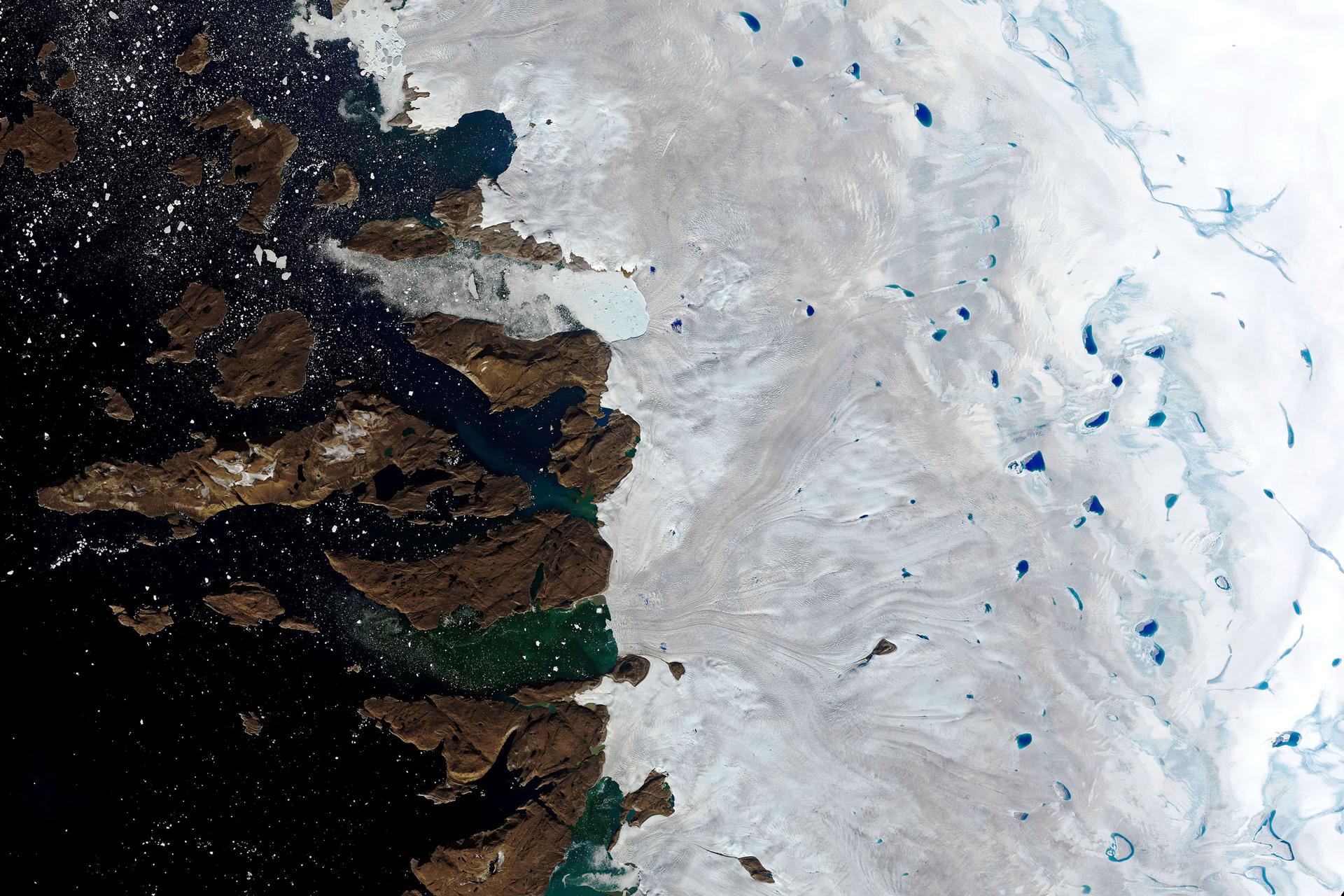 This Monday, July 30, 2019 natural-color image made with the Operational Land Imager (OLI) on the Landsat 8 satellite shows meltwater collecting on the surface of the ice sheet in northwest Greenland near the sheet's edge.