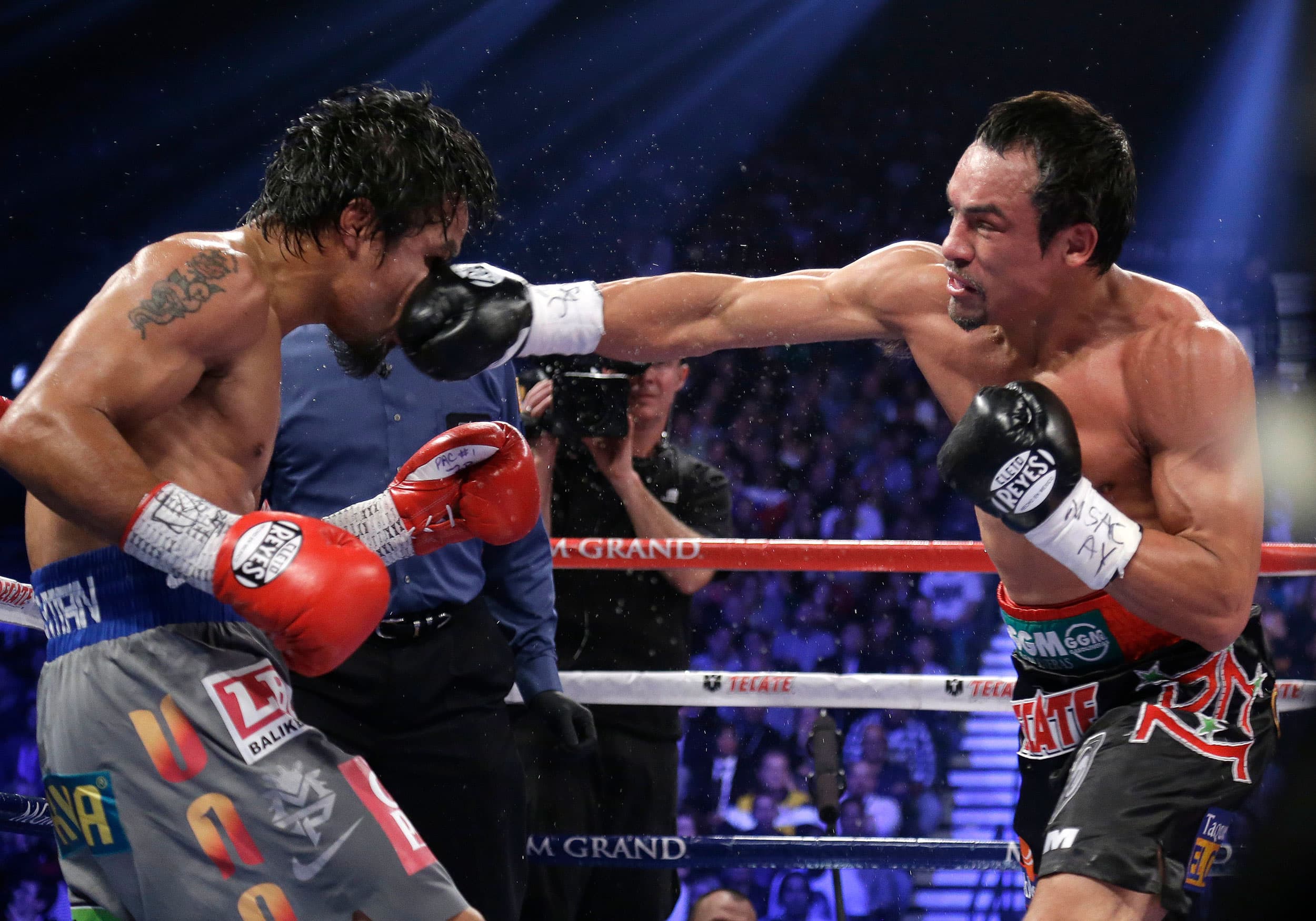 In this Dec. 8, 2012 file photo, Mexico's Juan Manuel Marquez lands a right to the head of Manny Pacquiao, from the Philippines, during their WBO world welterweight fight, in Las Vegas.