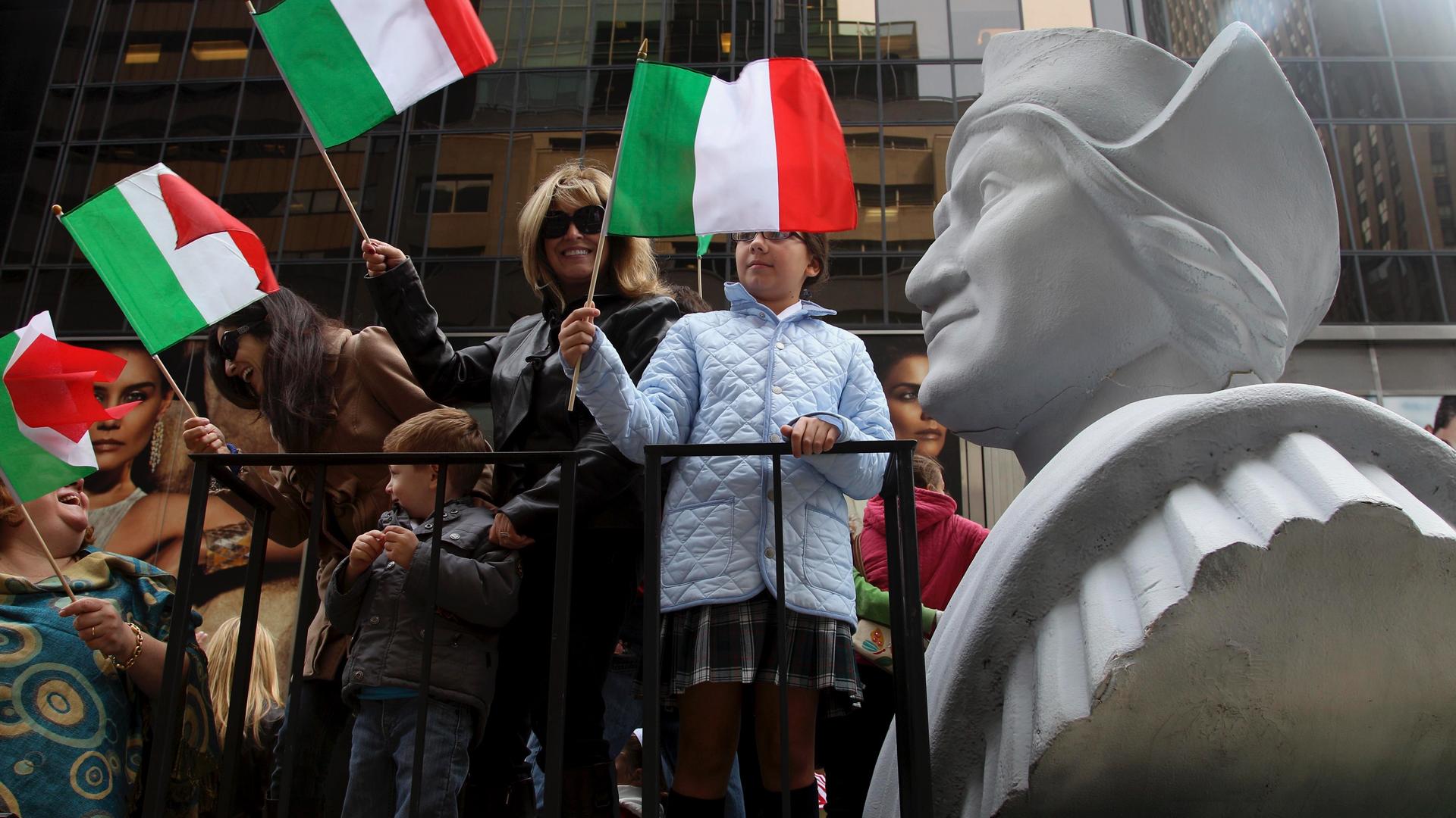 People ride on a float with a large bust of Christopher Columbus during the Columbus Day parade in New York, Oct. 8, 2012. The Oct. 12 federal holiday dedicated to Christopher Columbus continues to divide those who view the explorer as a representative of