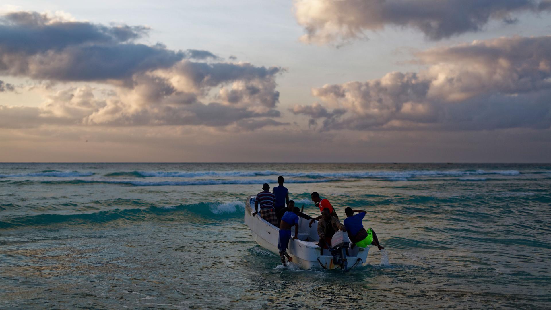 In this photo taken Tuesday, March 7, 2017, fishermen set out for their day's work in the Indian Ocean shortly after dawn in the former pirate village of Eyl, in Somalia's semiautonomous northeastern state of Puntland. 