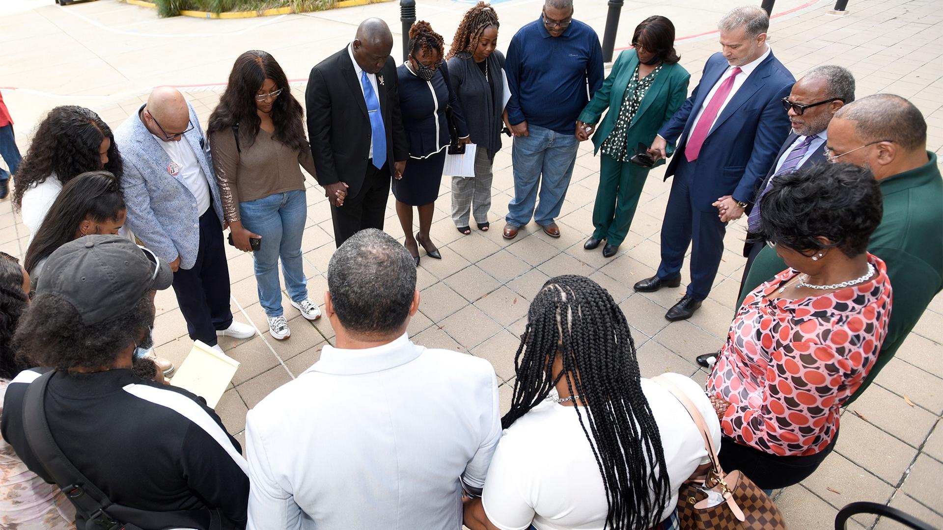Descendants of Henrietta Lacks, whose cells, known as HeLa cells, have been used in medical research without her permission, say a prayer with attorneys outside the federal courthouse in Baltimore