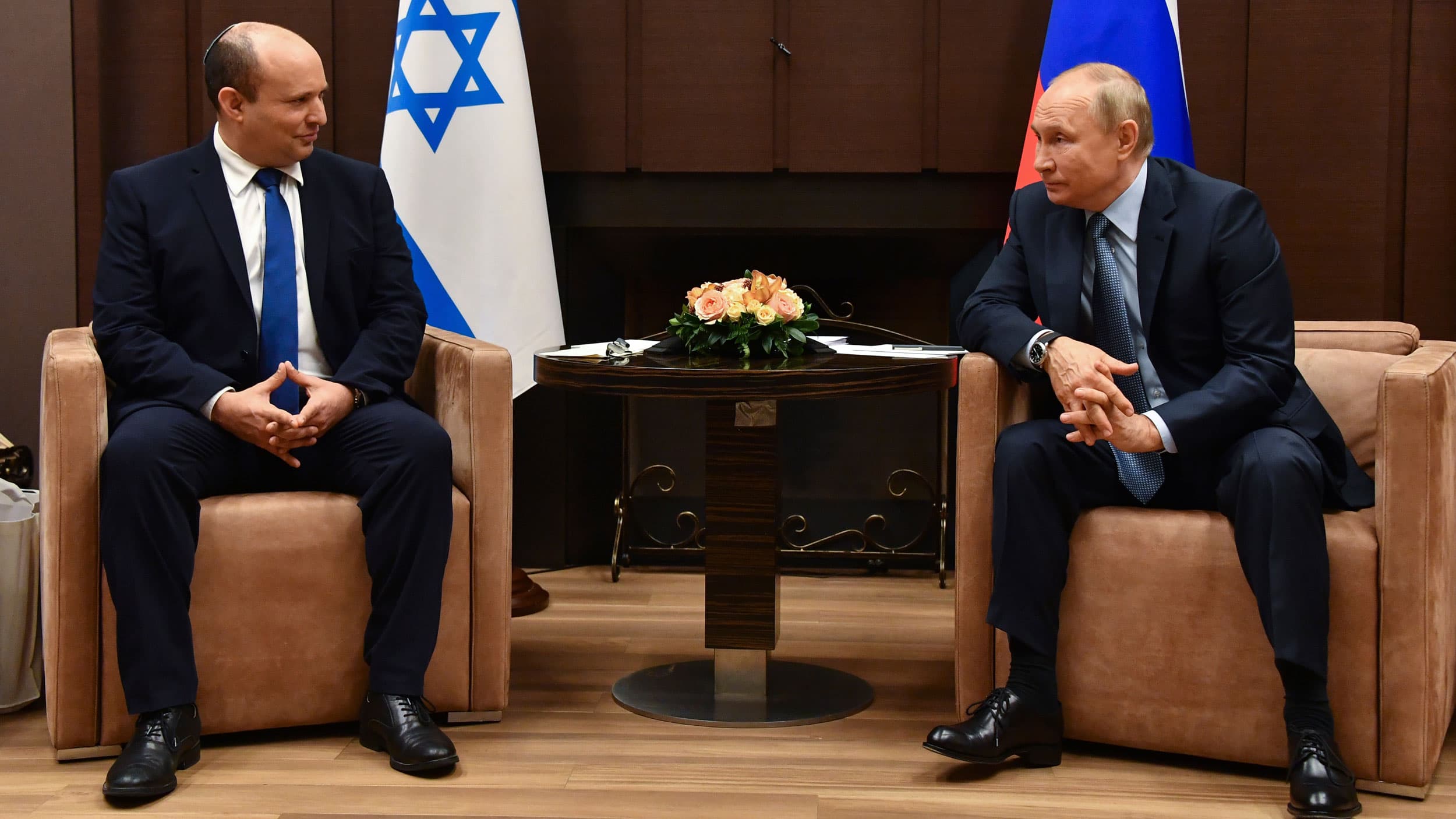 Russian President Vladimir Putin, right, and Israeli Prime Minister Naftali Bennett speak during their meeting in Sochi, Russia, Friday, Oct. 22, 2021.