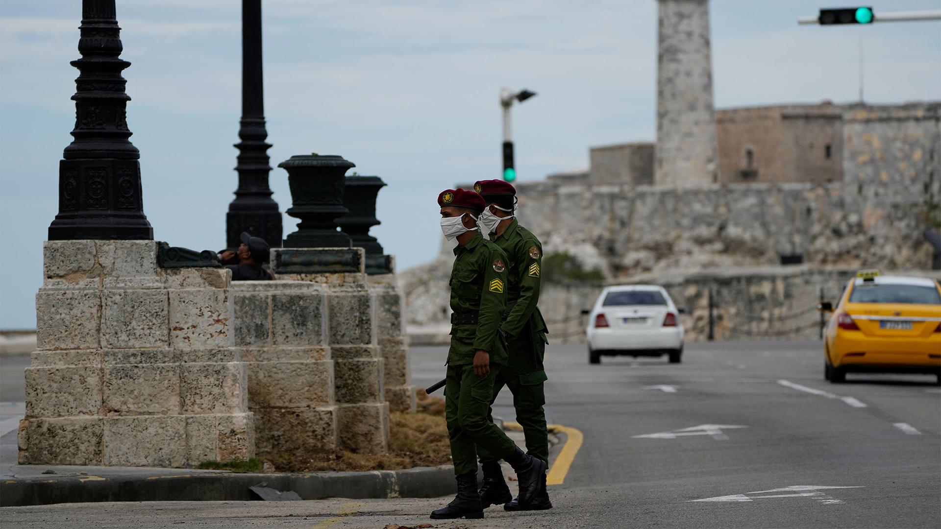 Soldiers patrol along the Malecón seawall in Havana, Cuba