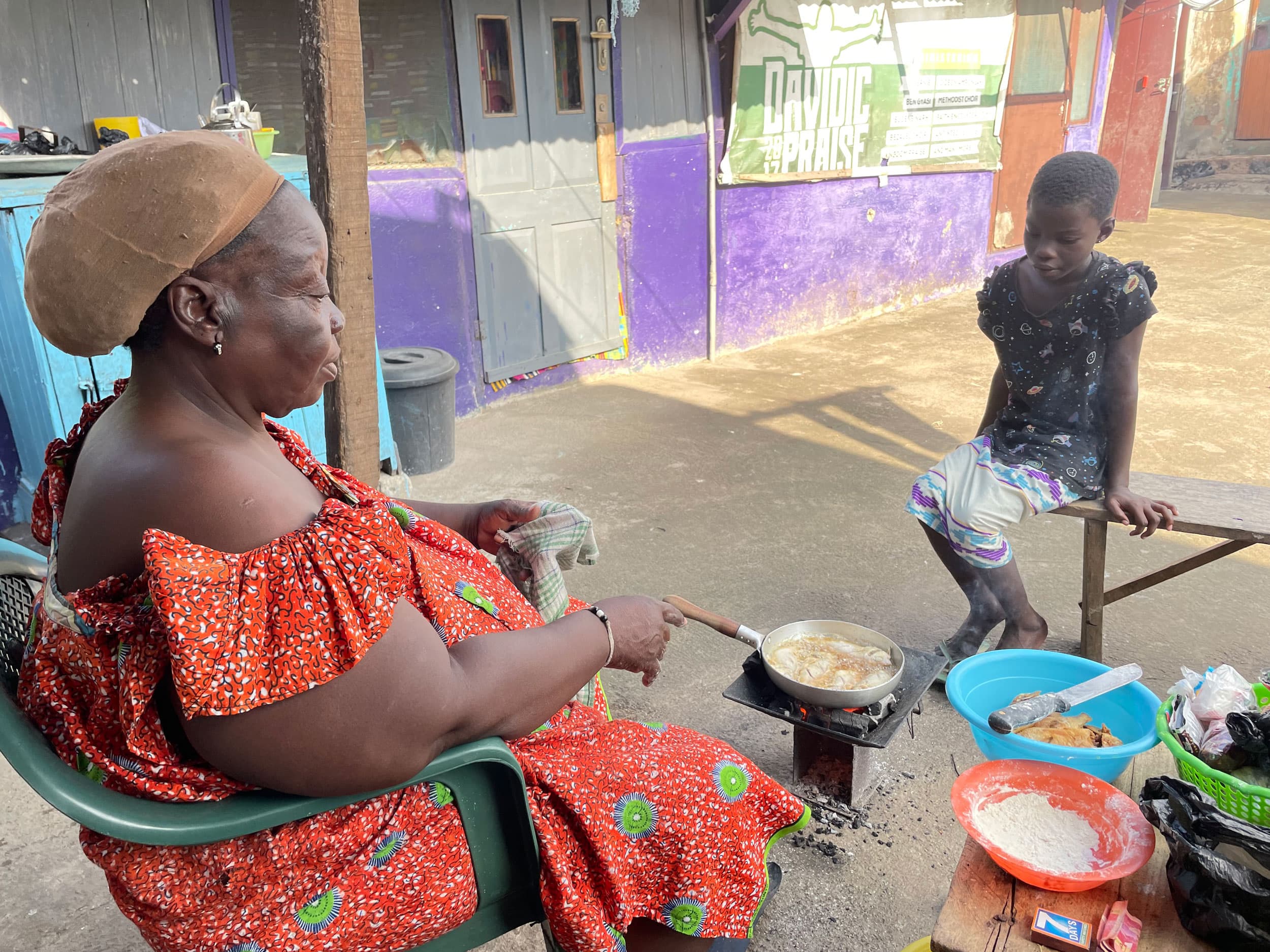 Rose Alhassan and her granddaughter are frying fish in the densely packed neighborhood of Nima in greater Accra, Ghana.
