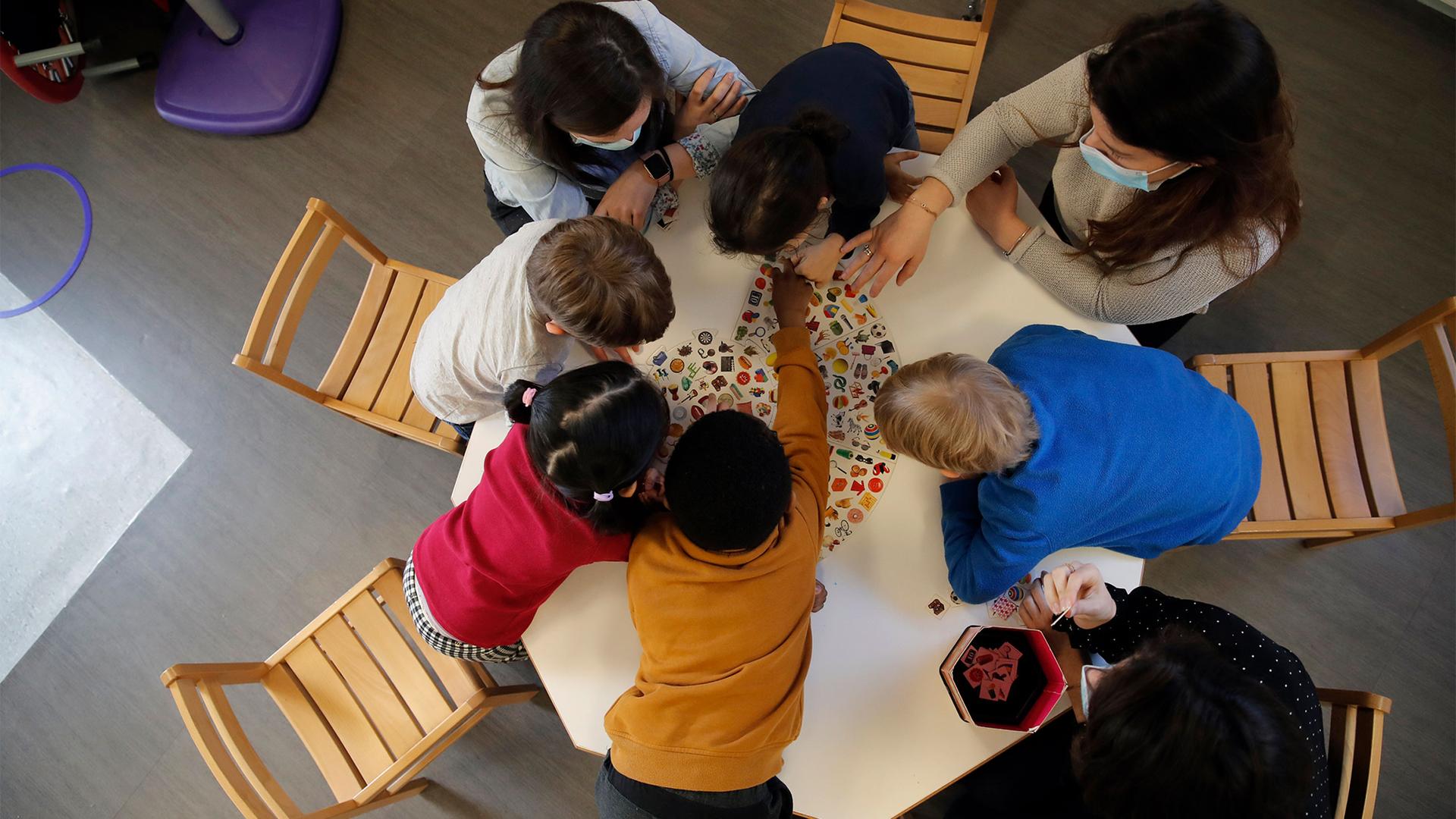 Children play with a therapist in the pediatric unit of the Robert Debre hospital, in Paris, France