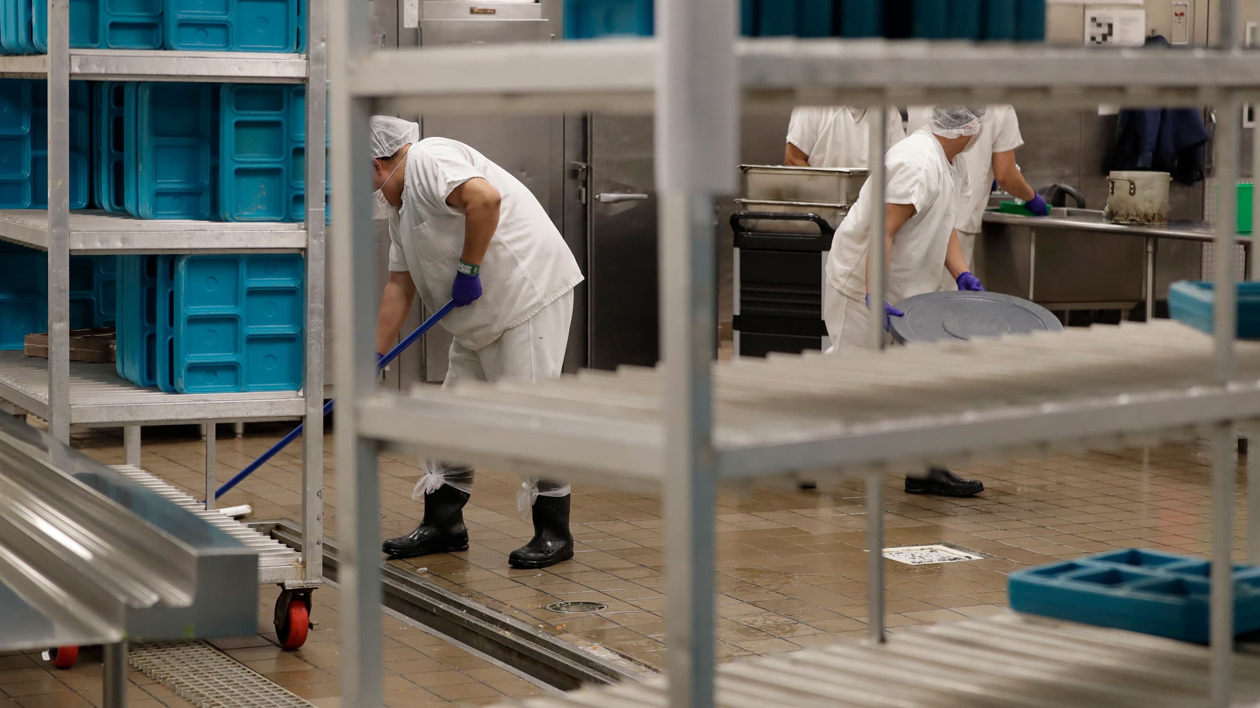 In this Sept. 10, 2019, workers are shown in the kitchen of the US Immigration and Customs Enforcement detention facility in Tacoma, Washington, during a media tour.