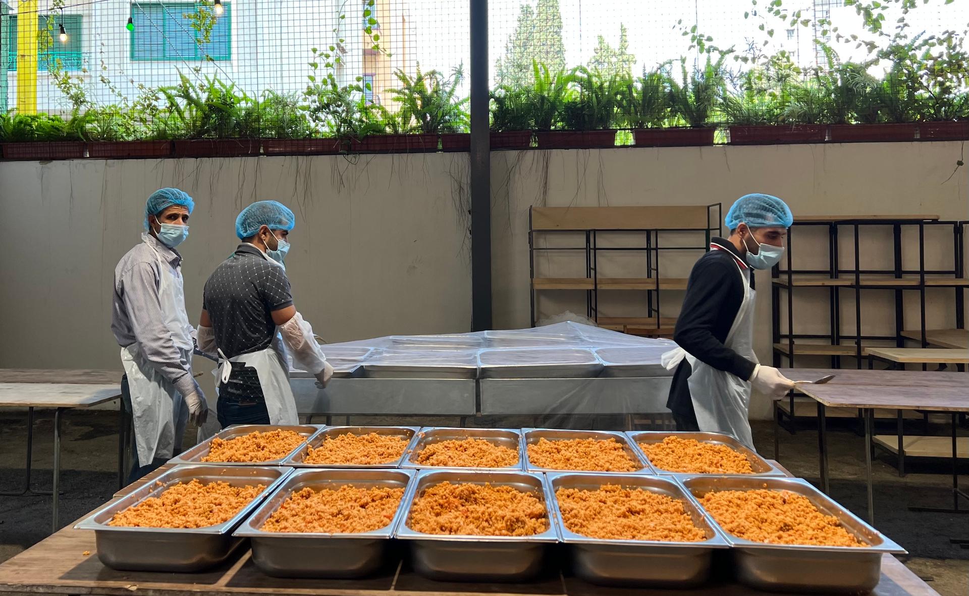 Workers at the Matbakh El Kell Community Kitchen in Beirut prepare food for distribution.