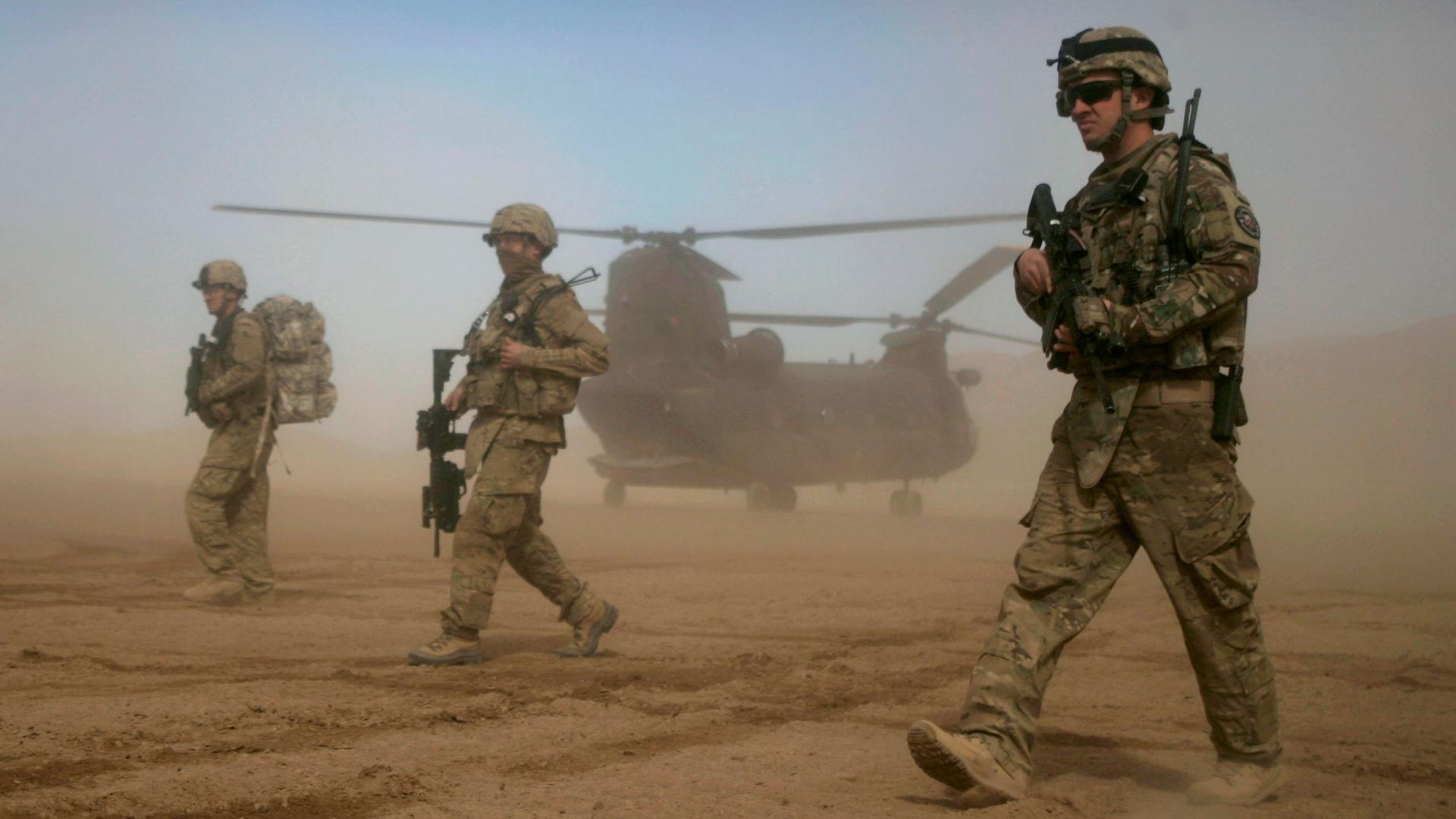In this Jan. 28, 2012 file photo, members of the NATO- led International Security Assistance Force (ISAF) patrol west of Kabul, Afghanistan. 