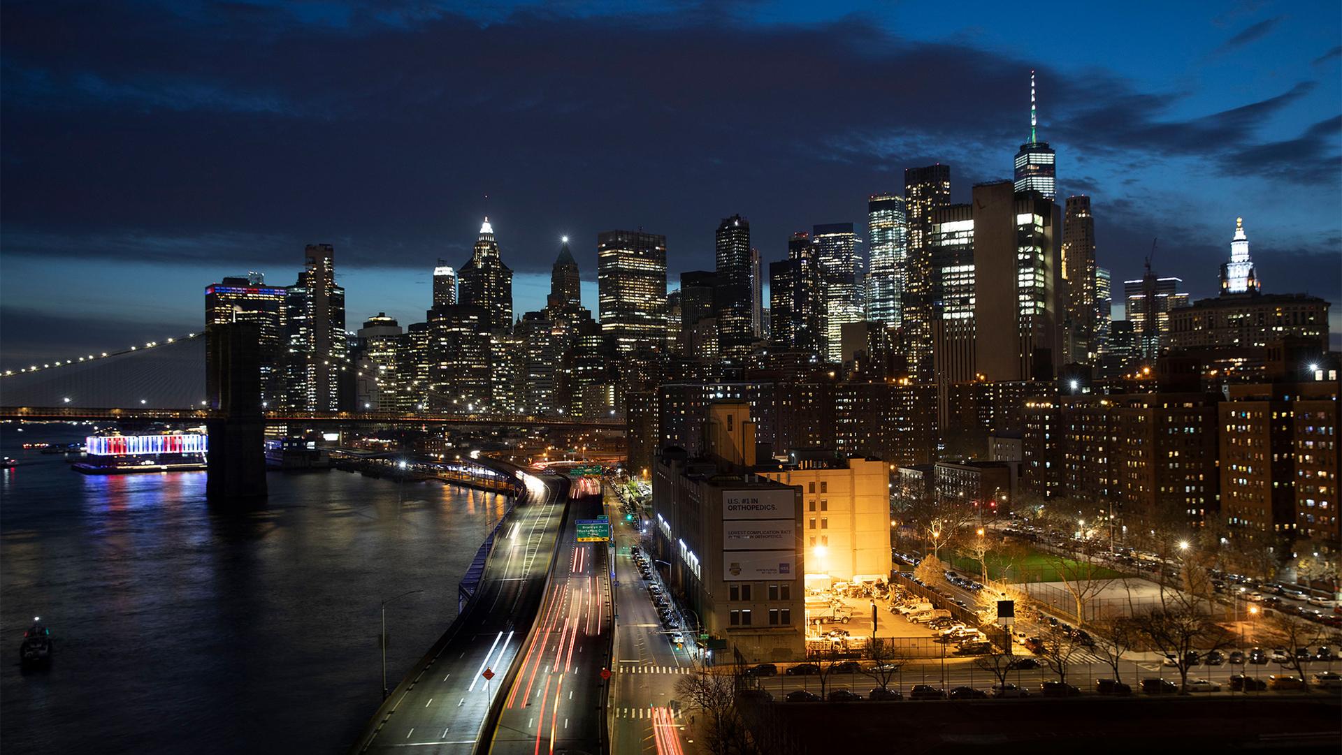 Cars head along FDR Drive next to the Manhattan skyline in New York