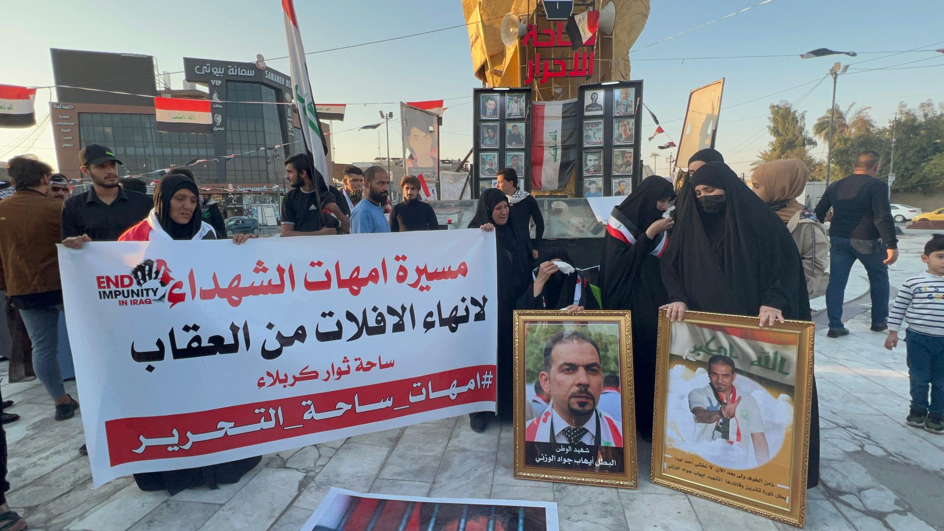 Samira Abbas, whose activist son Ehab al-Wazni was assassinated in May, attends a demonstration in Karbala on Nov. 18, 2021, with other women protesting the impunity Iraqi activists face.