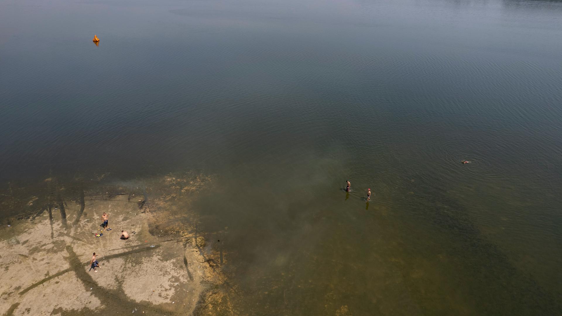 People bathe in the half-empty Guarapiranga Reservoir which provides water to the São Paulo metropolitan area, in Brazil, Sept. 20, 2021. Water levels have plunged during the ongoing dry season, bringing concerns about the water supply to São Paulo, the l