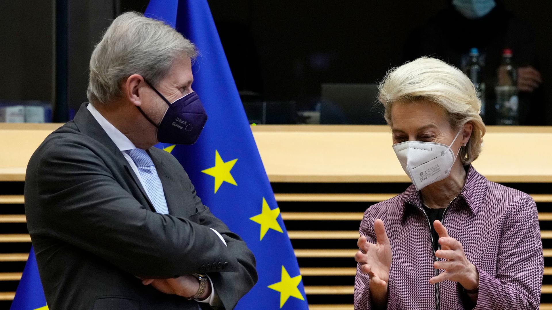 European Commission President Ursula von der Leyen, right, speaks with European Commissioner for Budget and Administration Johannes Hahn during a meeting of the College of Commissioners at EU headquarters in Brussels on Wednesday, Dec. 22, 2021. 