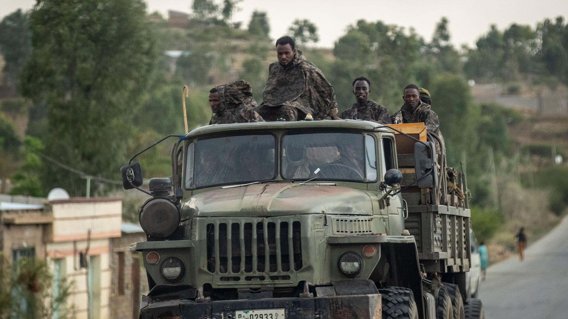 In this Tuesday, May 11, 2021, file photo, Ethiopian government soldiers ride in the back of a truck on a road leading to Abi Adi, in the Tigray region of northern Ethiopia. 