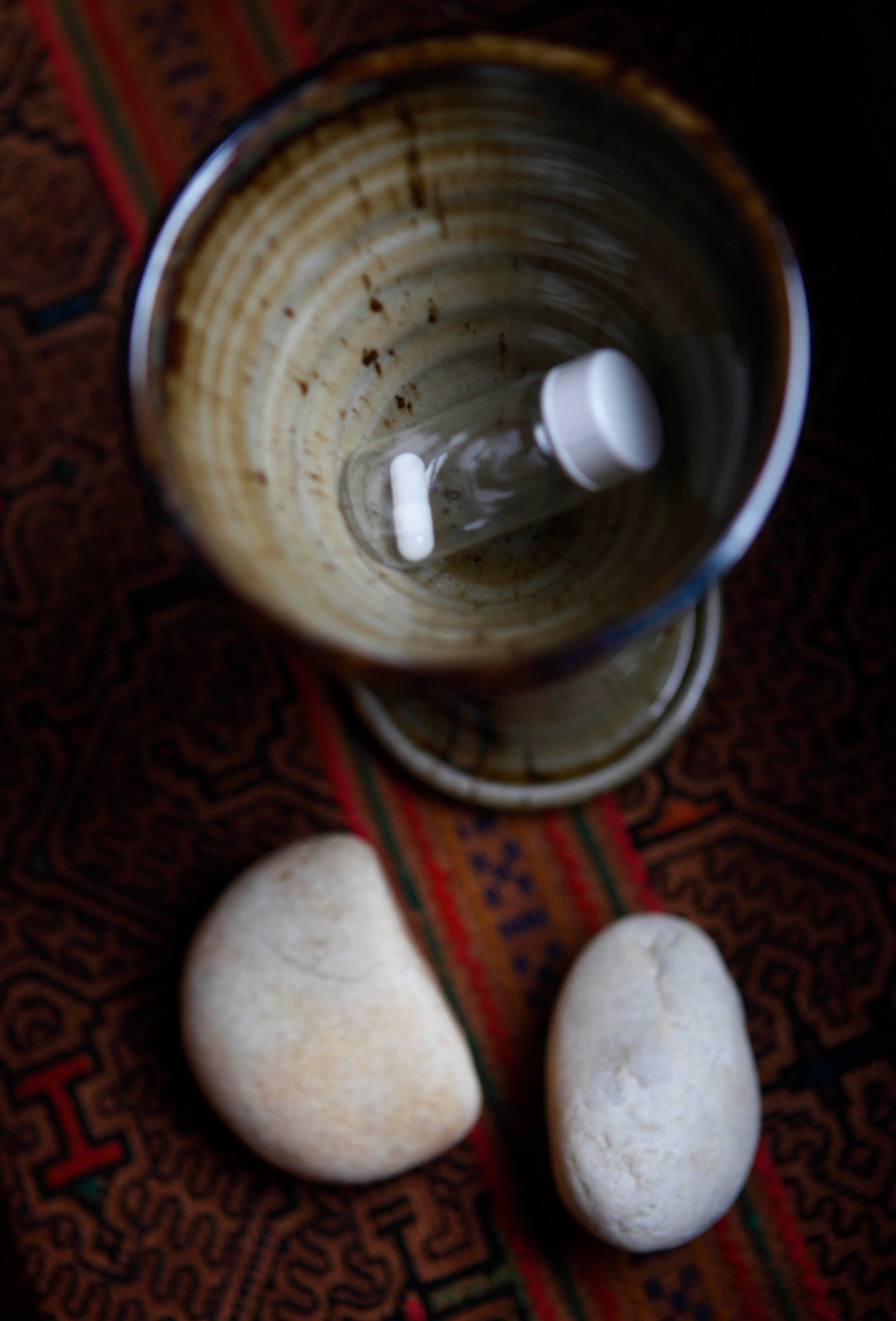 In this April 13, 2010 photo, for a study on the effects of hallucinogenic drugs on the psychological state of cancer patients, a pill is presented to the subjects in a chalice as seen here in New York.