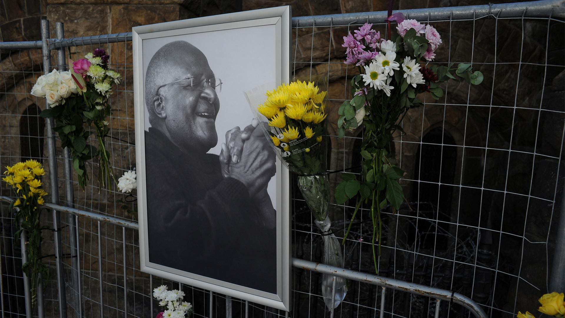 Flowers are placed alongside a photo of Anglican Archbishop Desmond Tutu at the St. George's Cathedral in Cape Town, South Africa
