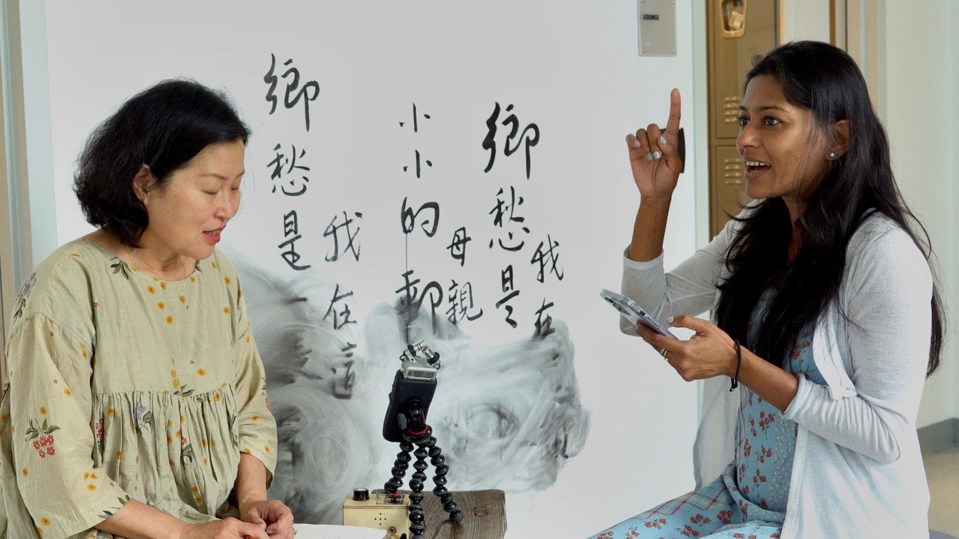 Taiwan-born artist Wen-hao Tien (left) started inviting people from around the world to teach her songs from their homelands as part her exhibit on immigration experiences at an art center in Boston, Massachusetts. 