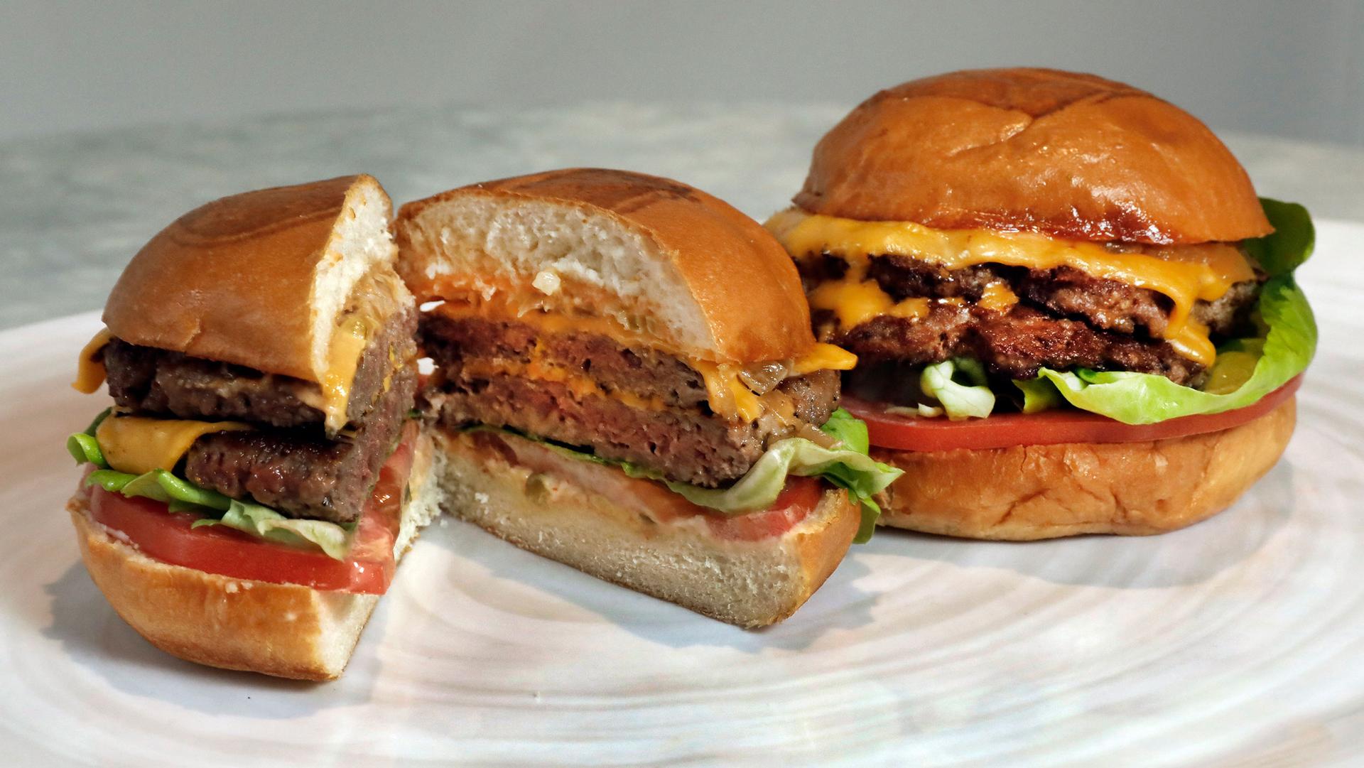 In this May 3, 2019, file photo, an Original Impossible Burger, left, and a Cali Burger, from Umami Burger, are shown in this photo in New York. 