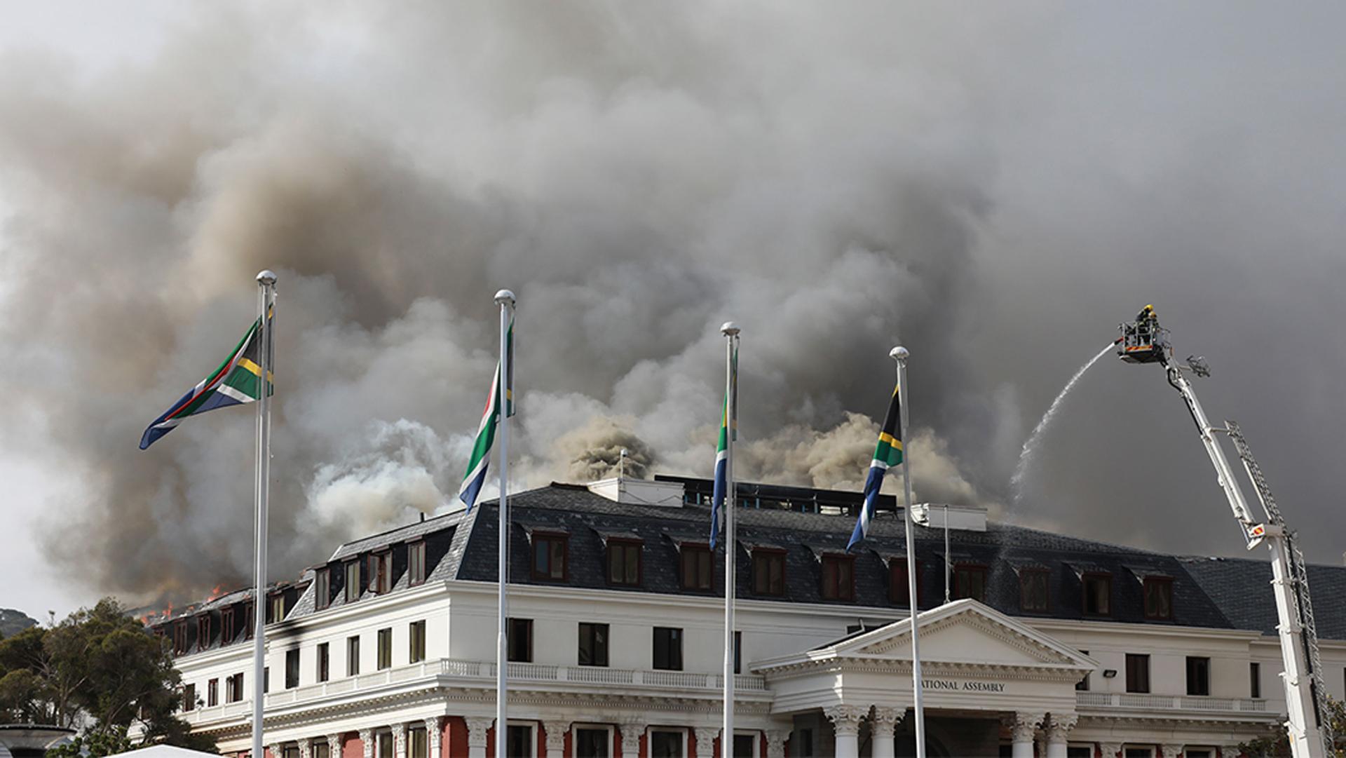 Smoke rises after fires re-ignited late afternoon from the Parliament in Cape Town, South Africa