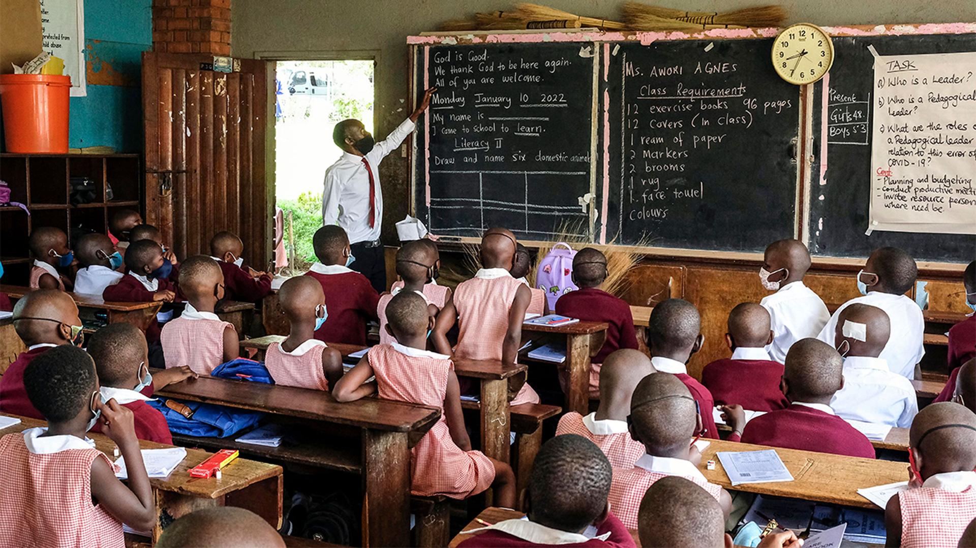 Pupils wear face masks as they attend class at Kitante Primary School in Kampala, Uganda