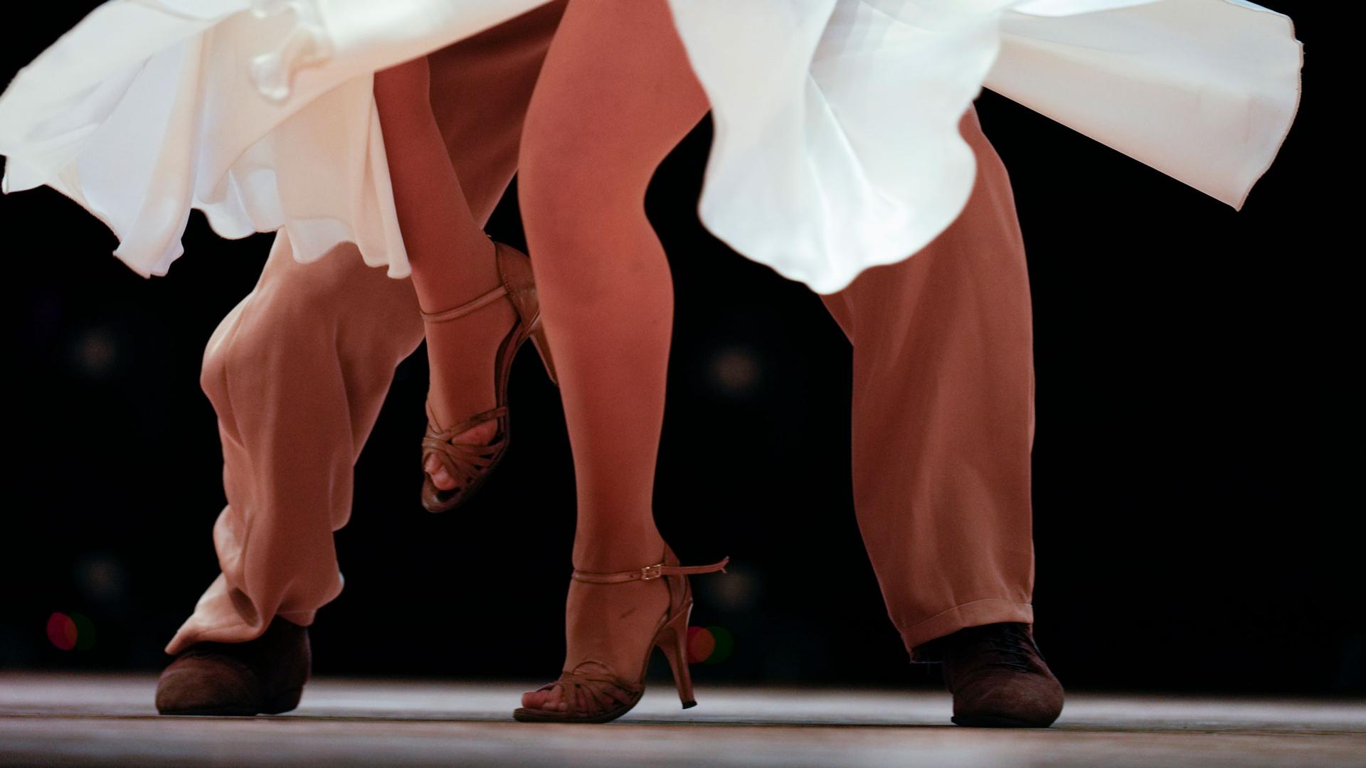 An image of male and female legs dancing in the final round of the stage category during the Tango World Championship in Buenos Aires, Argentina, Saturday, Sept. 25, 2021. 