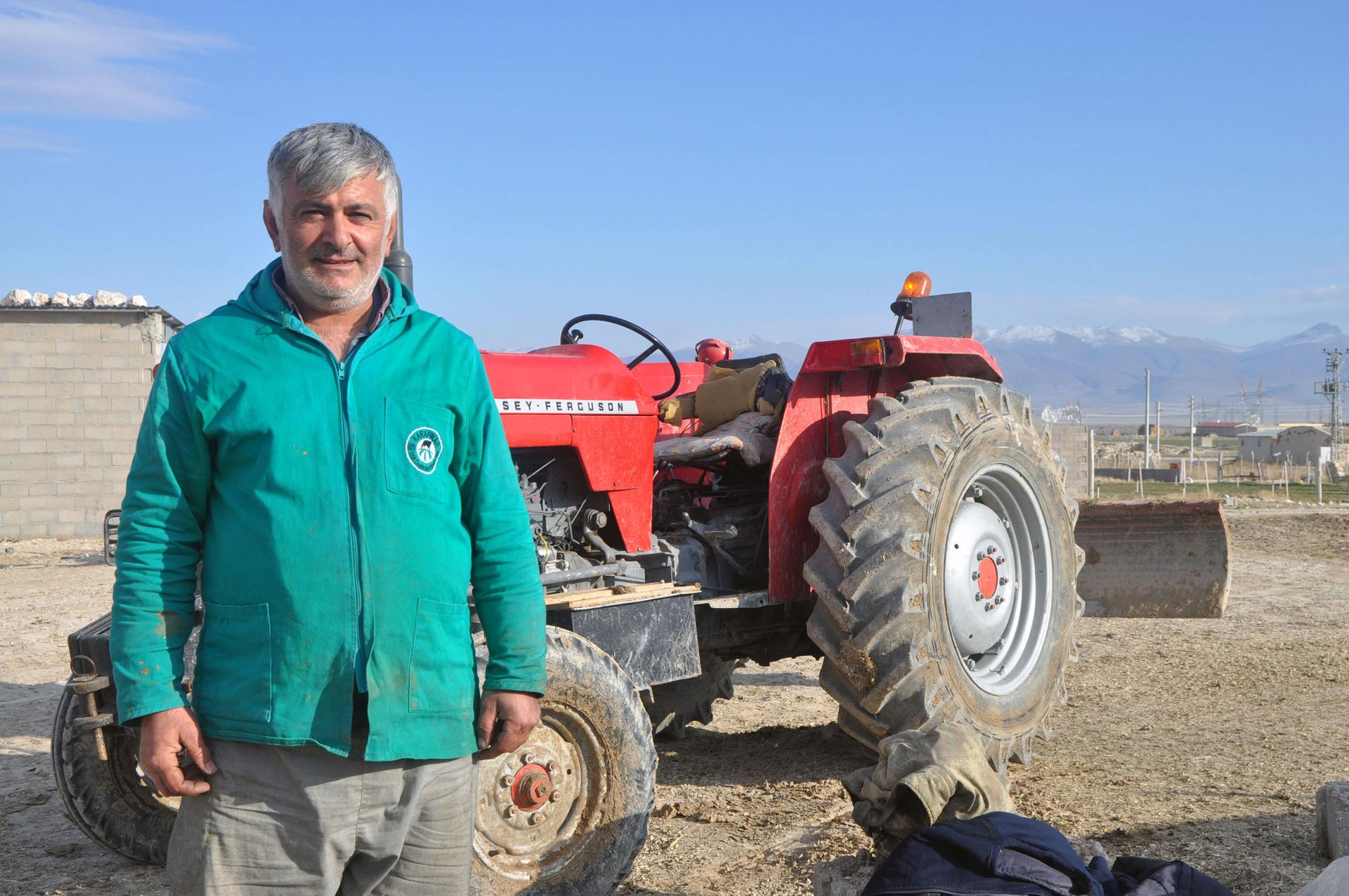 Mustafa Baldanoğlu takes a break from operating a tractor at his family’s dairy farm.
