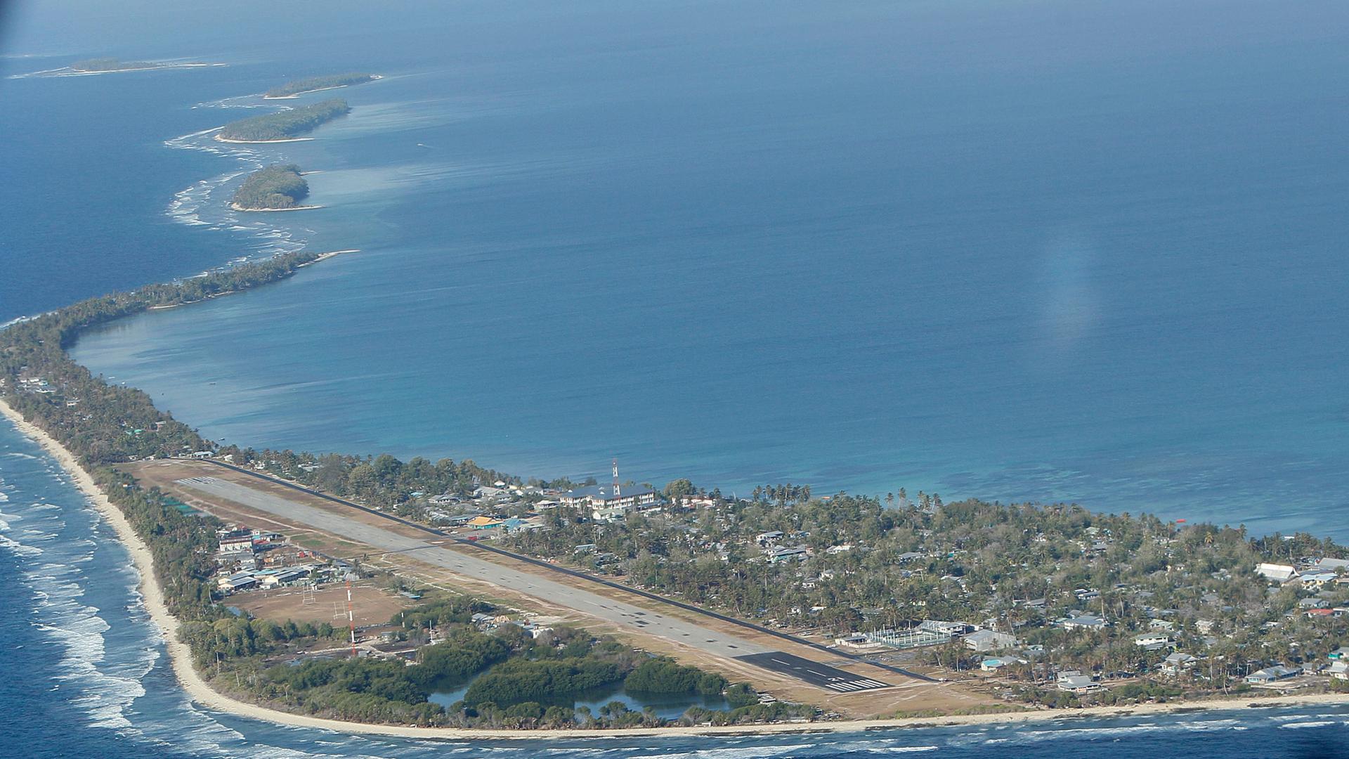 In this Oct. 13, 2011, file photo, Funafuti, the main island of the nation state of Tuvalu, is seen from Royal New Zealand Air Force's C-130 aircraft as it approaches at Funafuti, Tuvalu. 