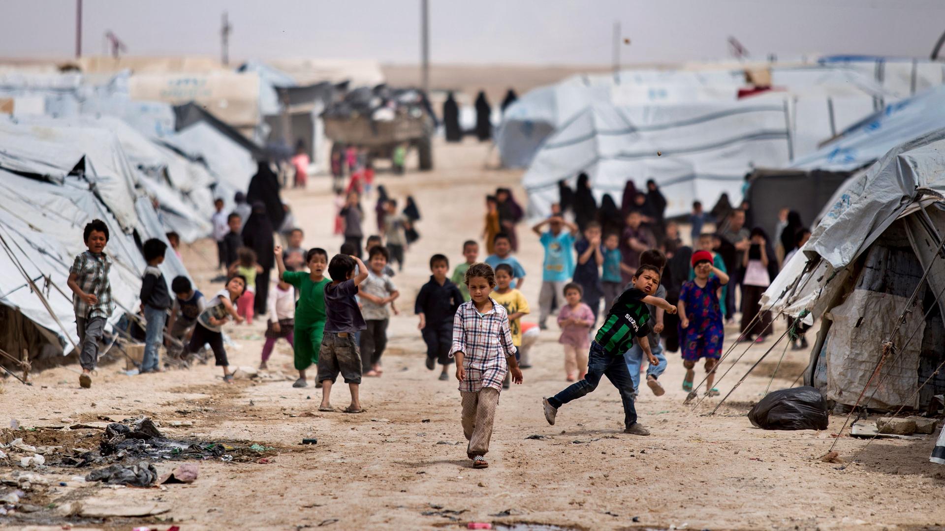 Children gather outside their tents, at al-Hol camp, which houses families of members of the ISIS group, in Hasakeh province, Syria, May 1, 2021. 