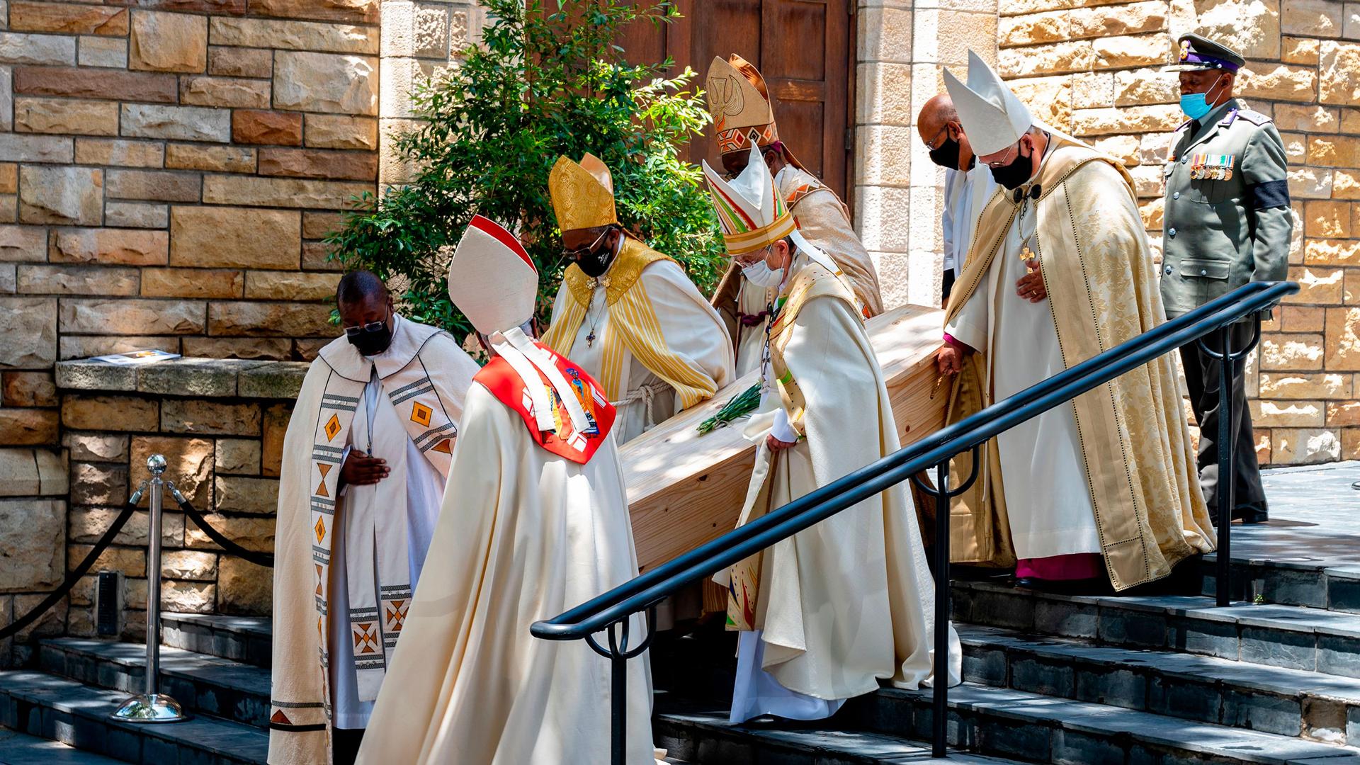 Clerics carry the coffin after the funeral for Anglican Archbishop Emeritus Desmond Tutu at the St George's Cathedral in Cape Town, South Africa, Saturday, Jan 1, 2022.