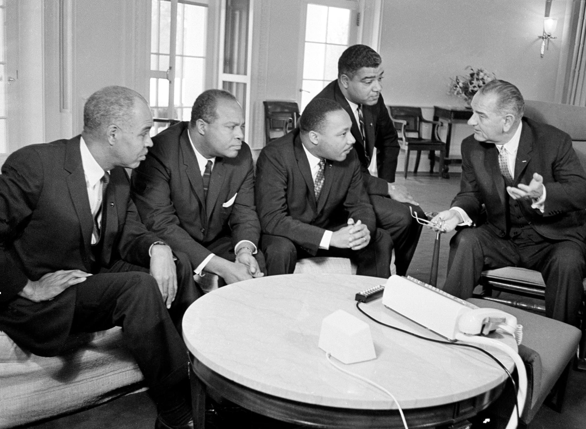 President Lyndon B. Johnson, right, talks with Martin Luther King Jr. and other civil rights leaders in his White House office in Washington, D.C., Jan. 18, 1964. 