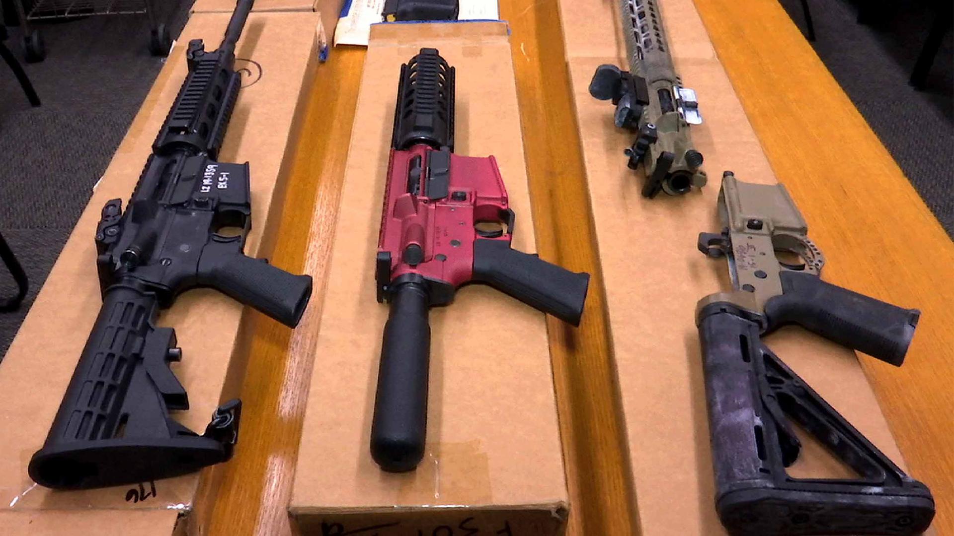 A display of a variety of guns on a table made from unauthorized parts