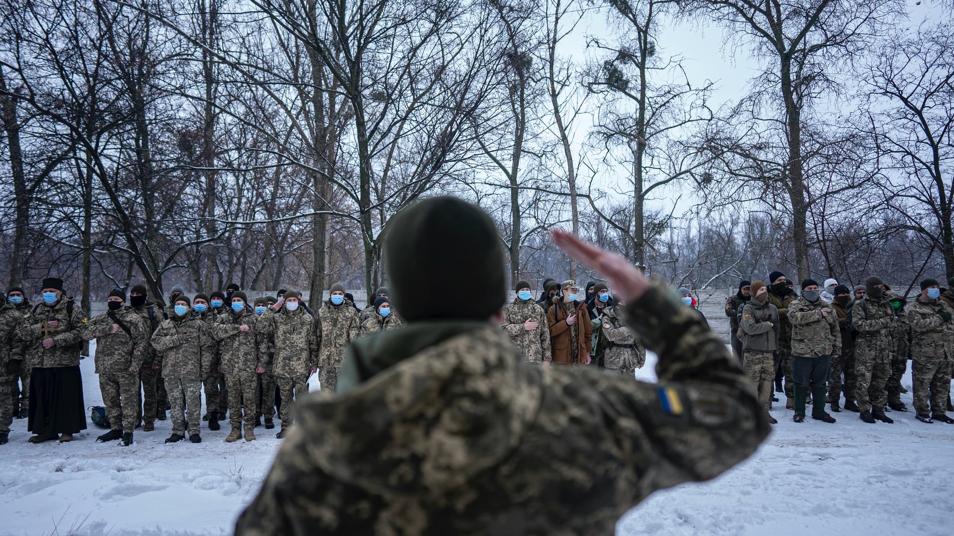 Members of Ukraine's Territorial Defense Forces, volunteer military units of the Armed Forces stay in line before training in Kharkiv, Ukraine, Jan. 29, 2022. Some people in Ukraine's second-largest city are preparing to fight back if Russia invades. Khar