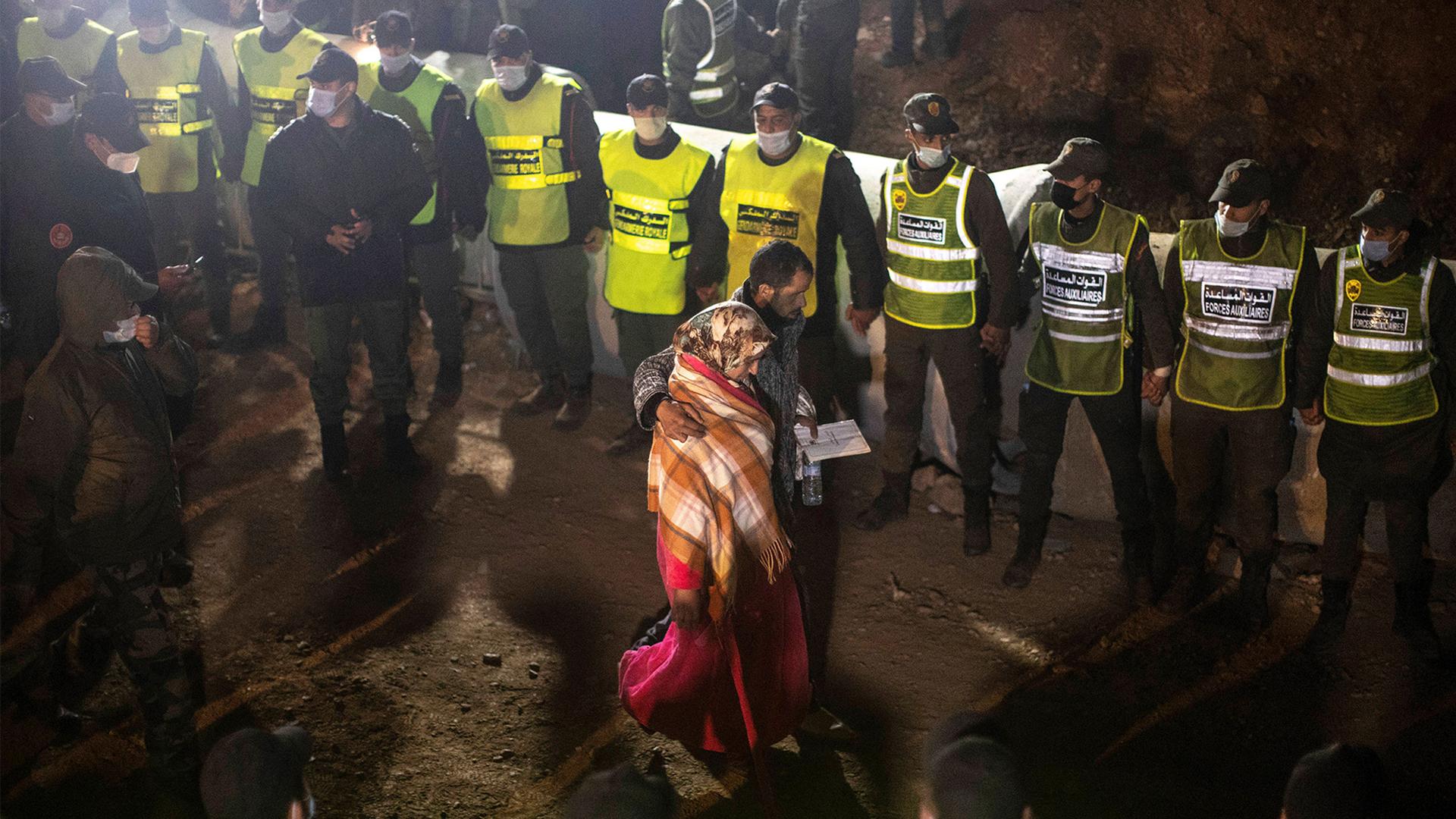 Parents of 5-year-old Rayan walk towards the tunnel as their son's body was being retrieved, after he fell into a hole and was stuck there for several days, in the village of Ighran in Morocco's Chefchaouen province