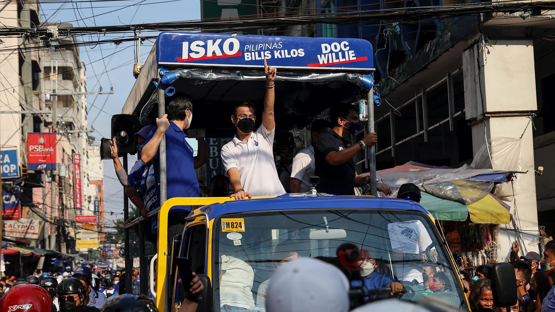Manila Mayor Isko Moreno, center, gestures as he greets his supporters during a motorcade promoting his presidential bid in the 2022 national elections in Manila, Philippines, Feb. 8, 2022. 