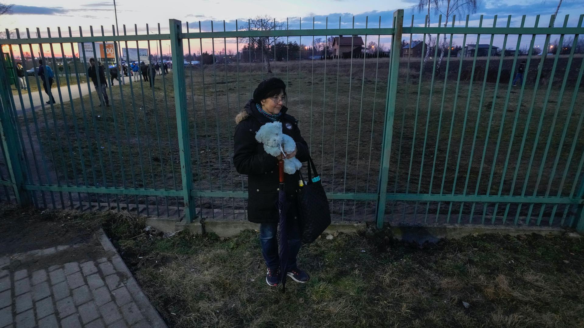 A Ukrainian woman waits for relatives fleeing the conflict from neighboring Ukraine at the border crossing in Medyka, southeastern Poland, on Feb. 25, 2022. UN officials said that 100,000 people were believed to have left their homes and estimated up to 4