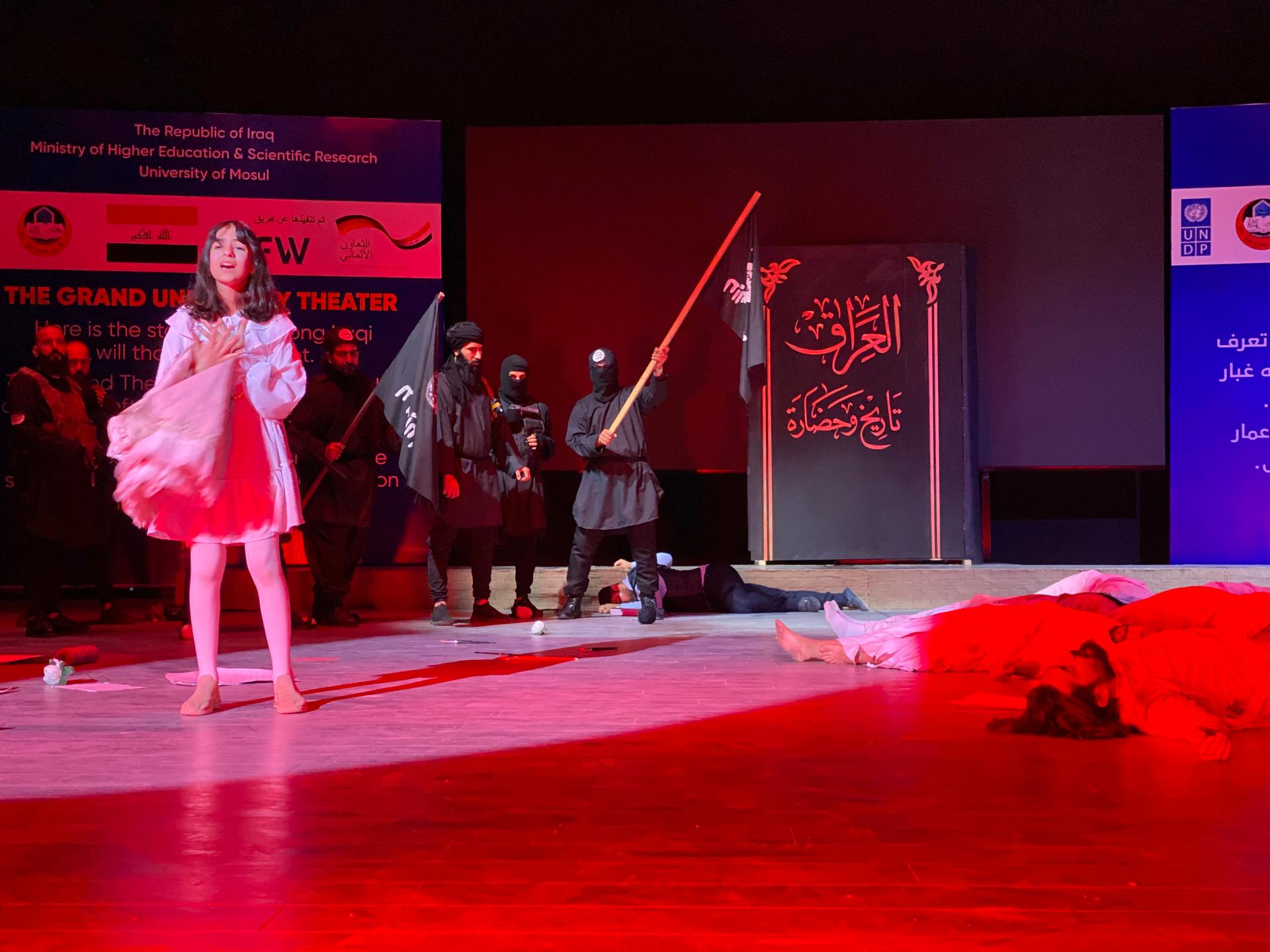 A play on stage at the University of Mosul features a dramatic reenactment of ISIS’ brutality, Feb. 19, 2022. 