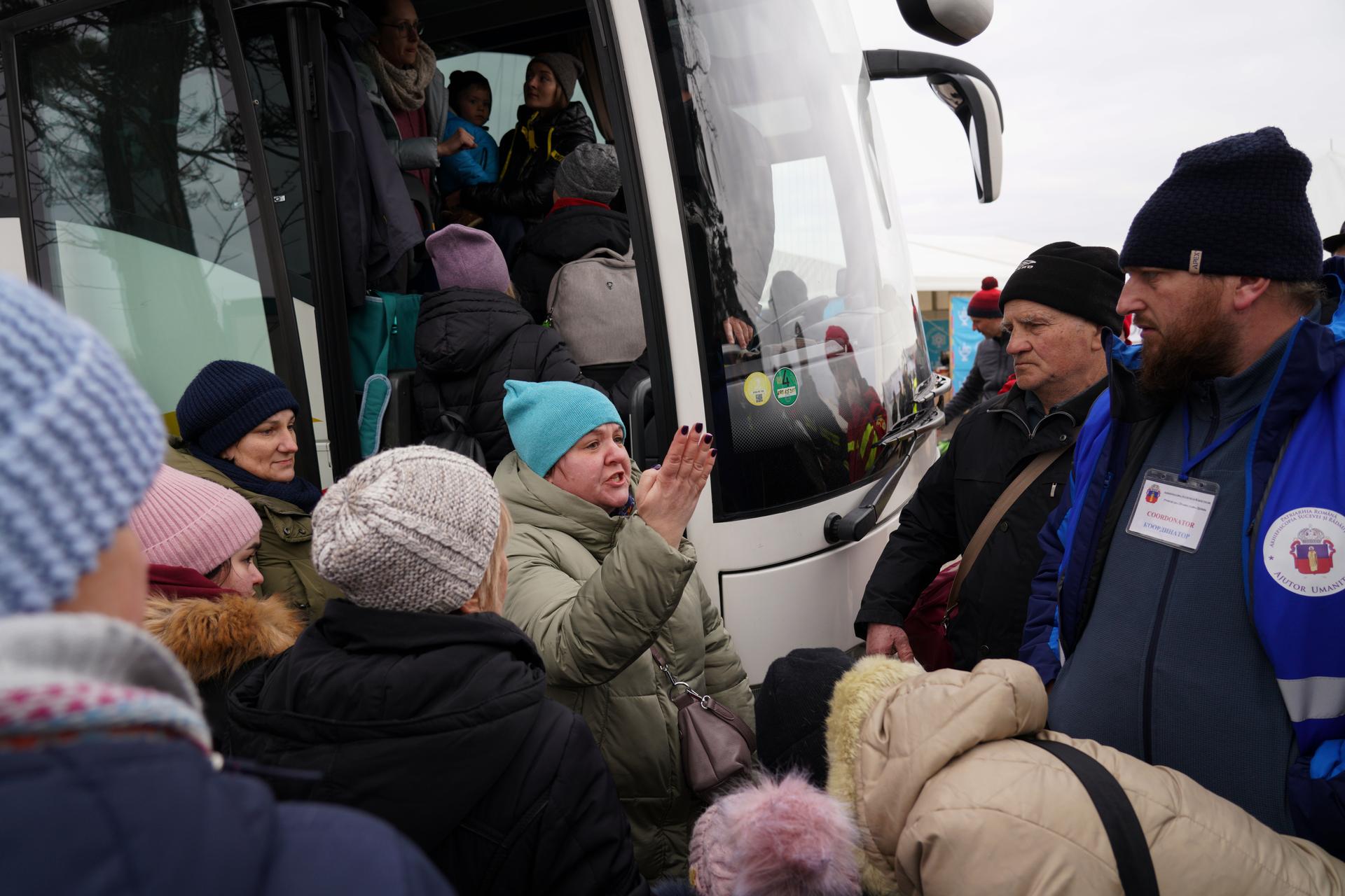 Amid a rush to board a bus to Berlin, one woman refugee from Ukraine panicked when she learned it was full but a volunteer assured her another was coming.