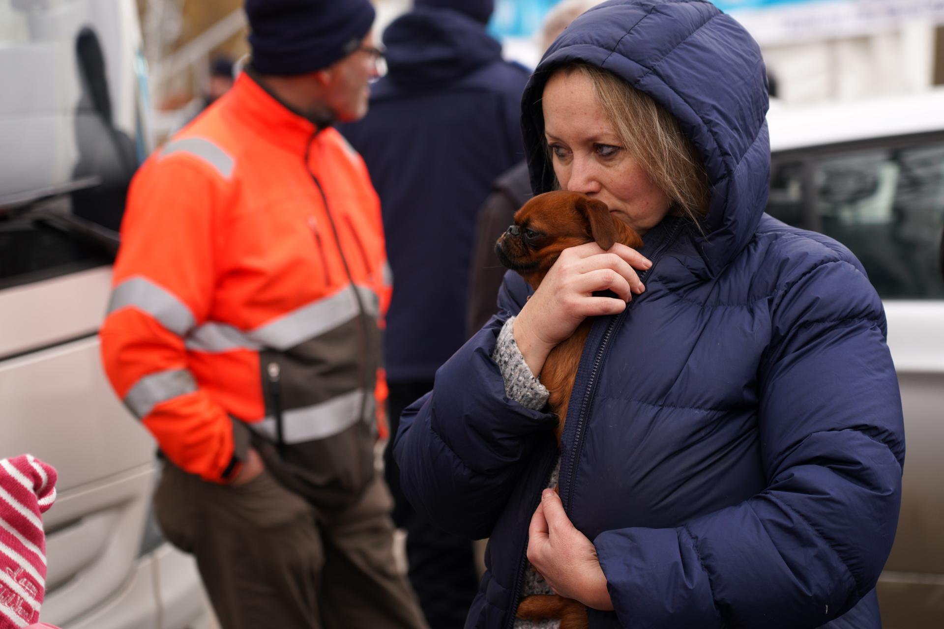 Ukrainian refugees are shown at customs in Siret, Romania, many of them traveling with just whatever they could carry — including their pets.