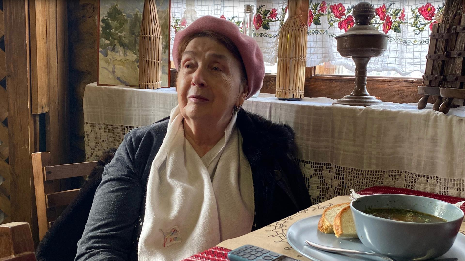 Natalya, a 70-year-old retired epidemiologist from Odessa, has lunch at the Asconi Winery near Chisinau, in Moldova, where she is being hosted for free. 