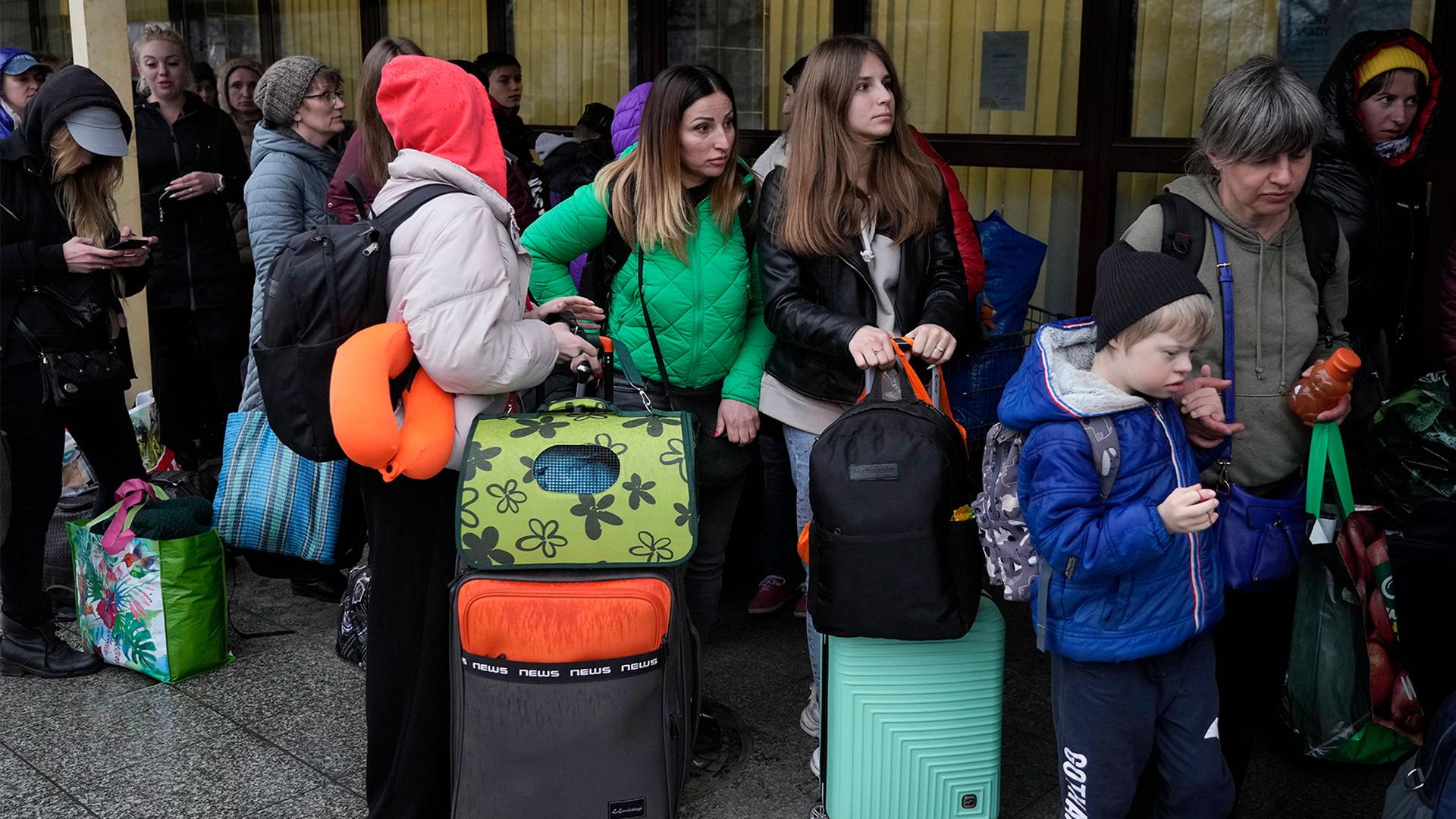 Refugees wait to travel back to Ukraine from the train station in Przemysl, southeastern Poland