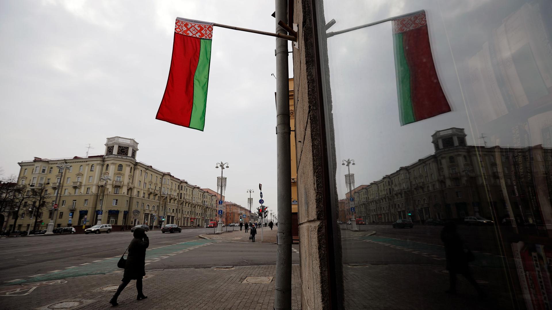 A Belarusian national flag flutters over a street in Minsk, Belarus, Wednesday, Feb. 16, 2022. 