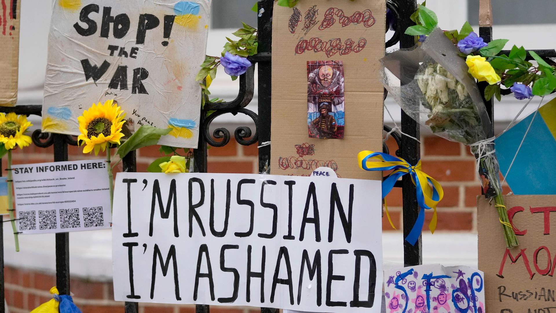 Placards and banners against the war in Ukraine hang opposite the Russian embassy in London, Friday, March 11, 2022.