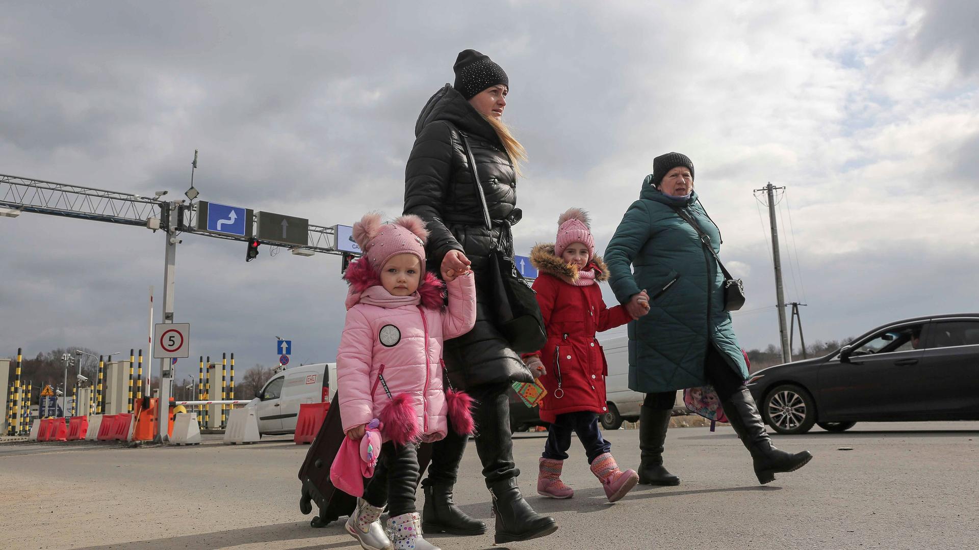 A family arrive at the border crossing in Medyka, Poland, Wednesday, March 2, 2022, after fleeing from the Ukraine. 