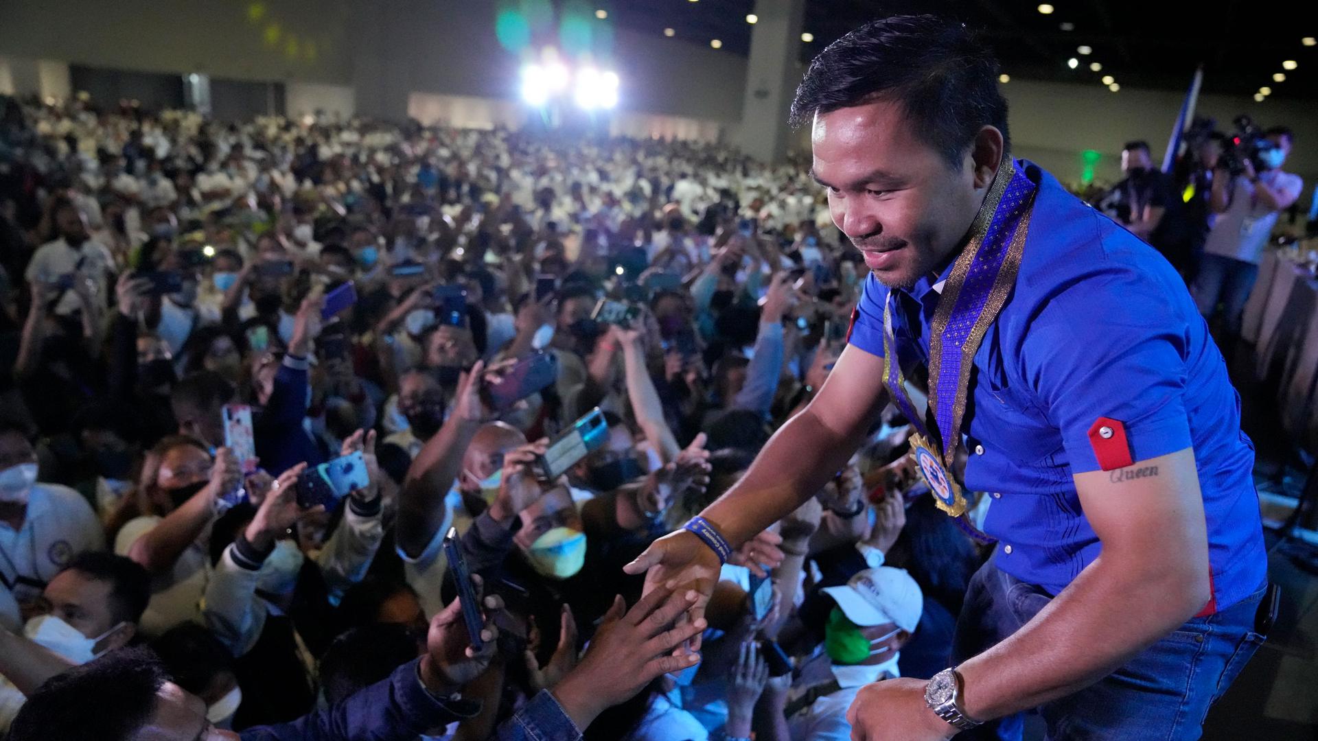 Boxing legend and presidential candidate, senator Manny "Pacman" Pacquiao greets the crowd in Pasay city, Philippines Monday, March 14, 2022. 