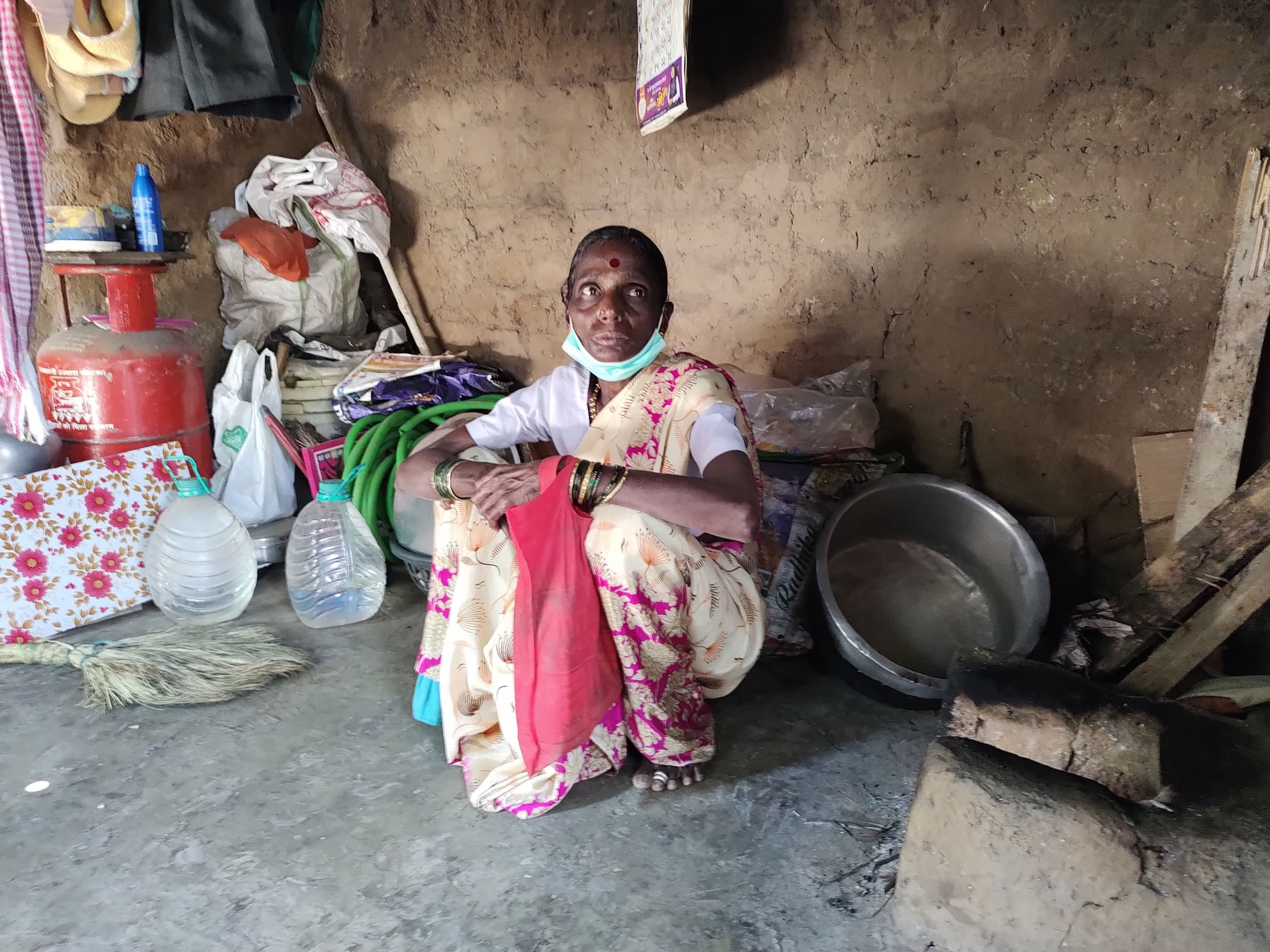 Onita Orsul uses her LPG cylinder as a makeshift dresser with hair oil and talcum powder stacked on it because she can not afford to fill it with gas.