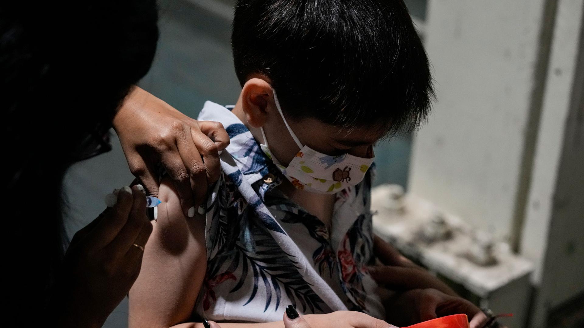 A 5-year-old boy gets his first dose of China's Sinovac vaccine, at a vaccination center in Santiago, Chile, Monday, Dec. 6, 2021. 