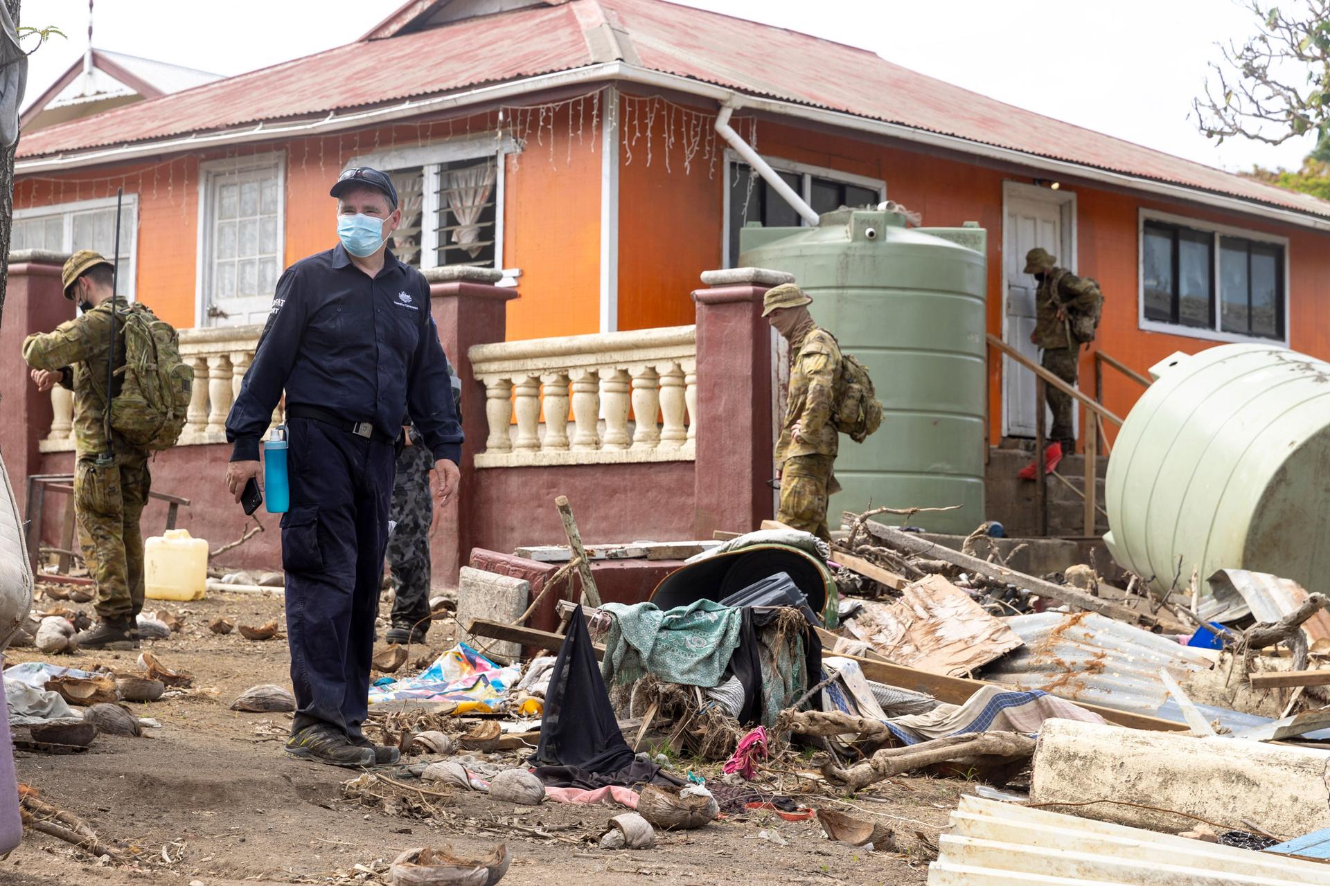 In this photo provided by the Australian Defense Force, Australian Defence Force and Department of Foreign Affairs & Trade crisis response team personnel make a damage assessment operation in Nuku'alofa, on Atata island in Tonga, following the eruption of